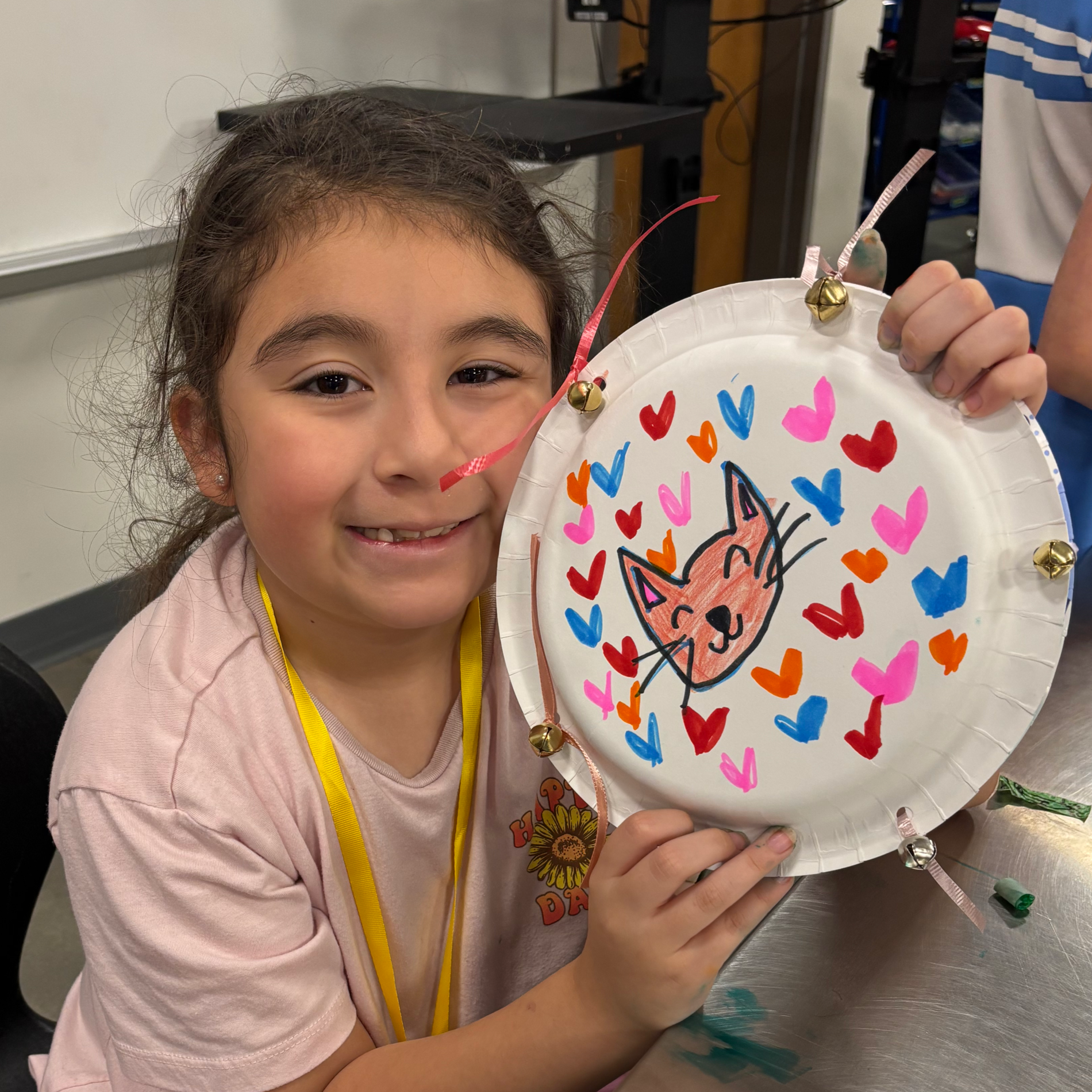 Photo of Summer Music Camp student showing off the tambourine they made in crafts!