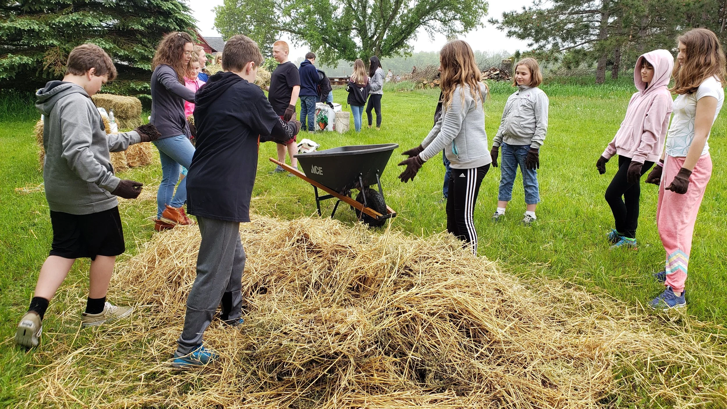 Building compost piles that will provide organic nutrients to the fields