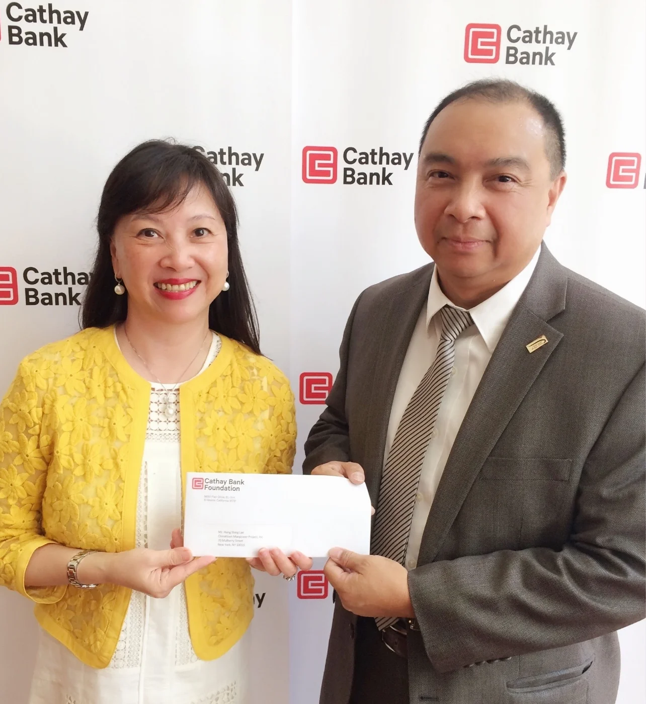 Cathay Bank Senior Vice President Ms. Elizabeth Lee (left) is handing over the donation check to CMP Executive Director Mr. Hong Shing Lee (right).