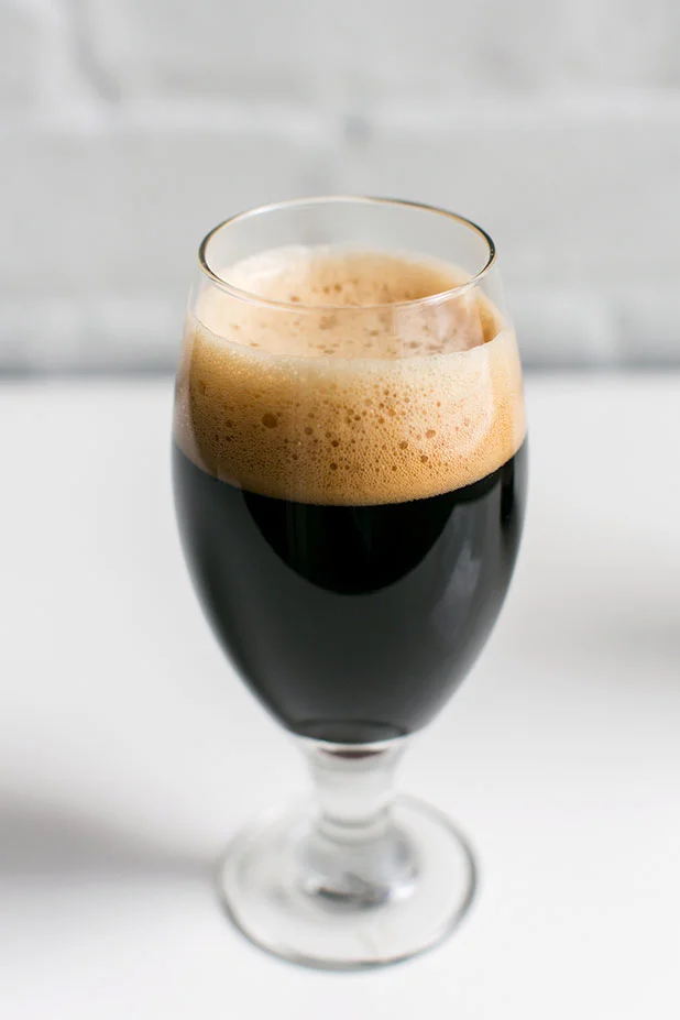 Stout beer photo with creamy head and white background