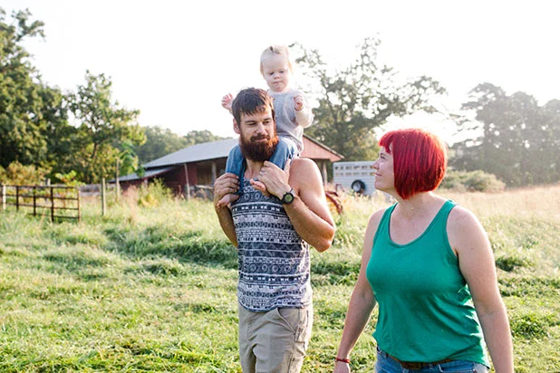 Family at Shirefolk Farm walking in field - Sarah Der
