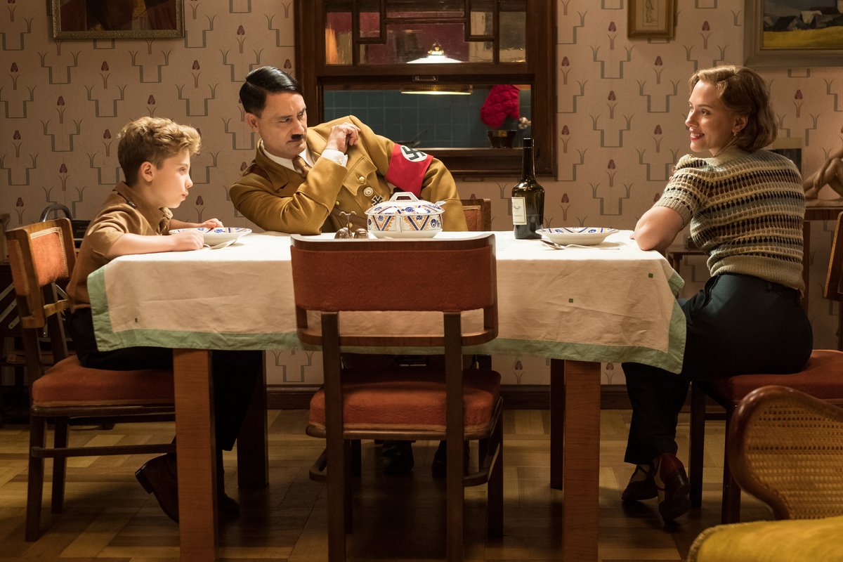 From left: Roman Griffin Davis as Jojo, writer/director Taika Waititi as his imaginary friend Adolf and Scarlett Johansson as his mother Rosie in the upcoming World War II satire Jojo Rabbit .