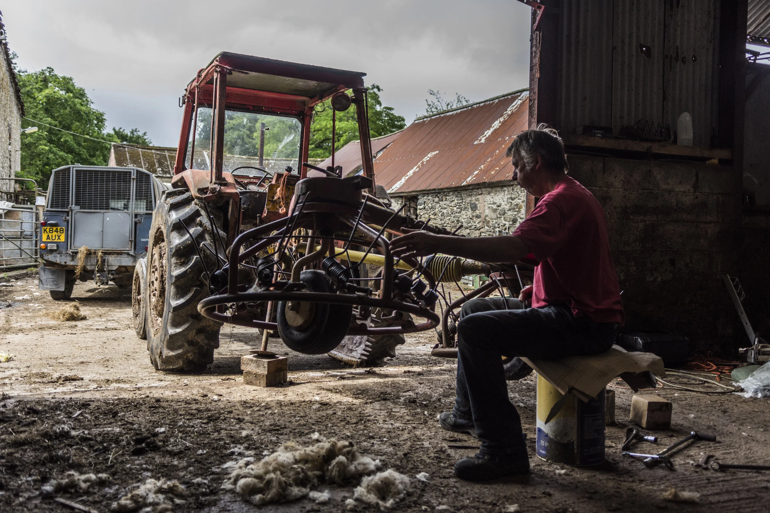 Dad replacing the springs/spikes on the hay-bob for the coming harvest.
