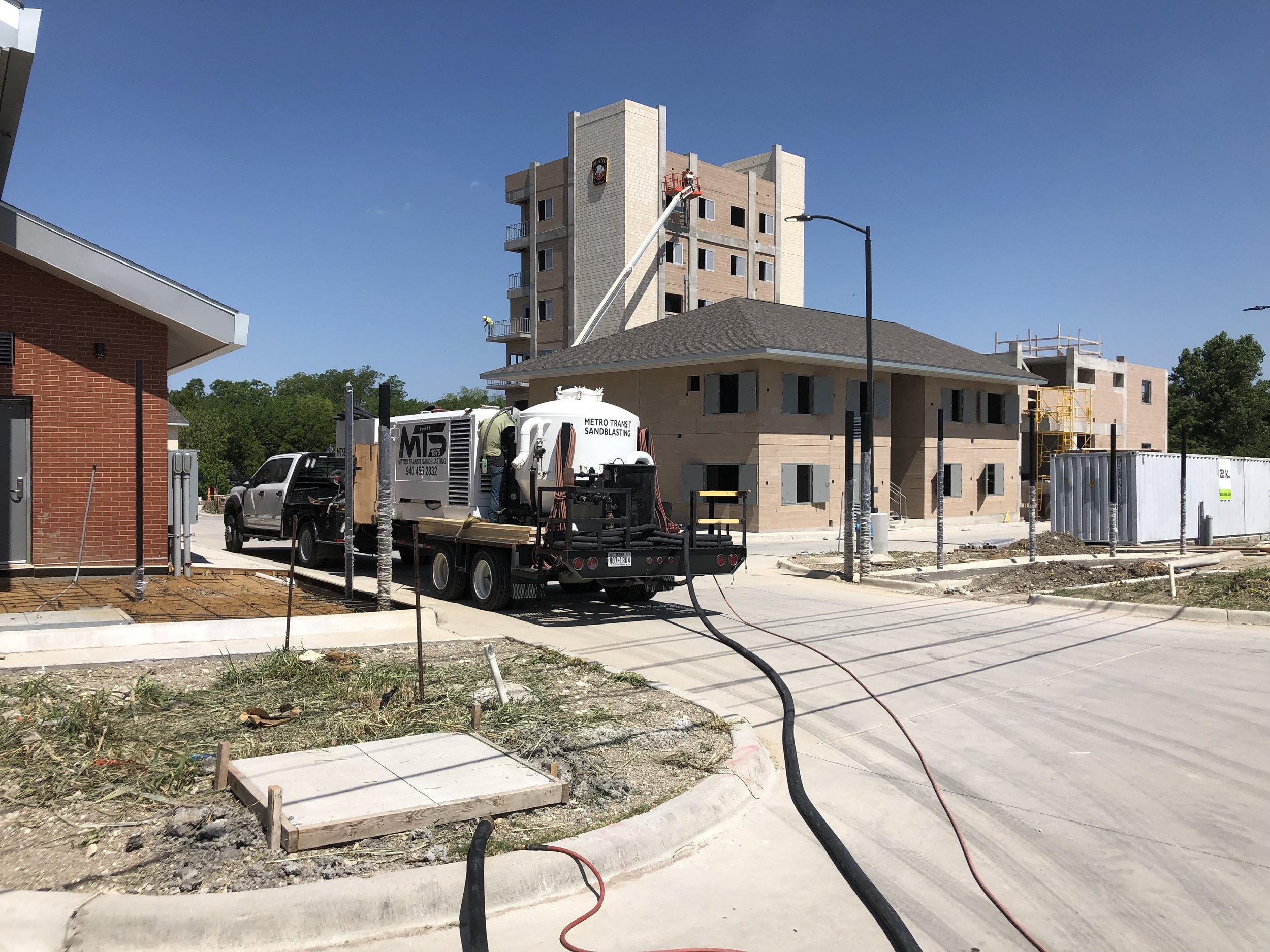 Sandblasting concrete at Plano Fire Academy in Plano, TX
