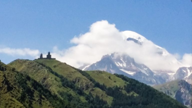 Kazbegi peak and Gergeti Church as viewed from the town. 