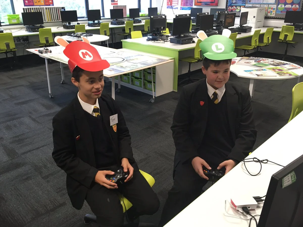 "Digital Leaders taking a break playing Mario Kart with their hats on. Team Luigi or Team Mario? Vote now!!"