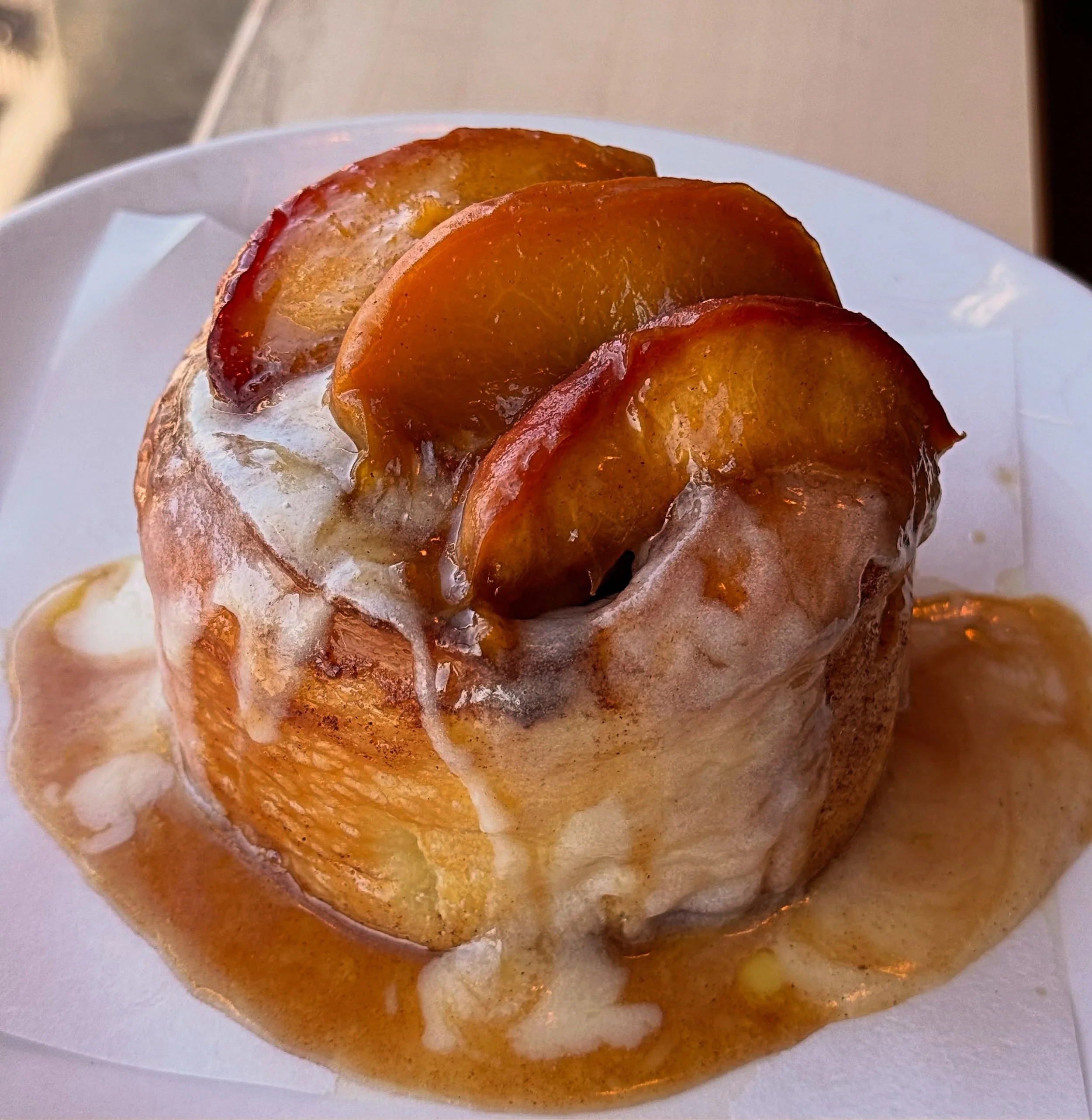 Peaches are here!! This is our peach challah cinnamon roll. Challah filled with a cinnamon &amp; nutmeg brown sugar butter and topped with cream cheese frosting &amp; local peaches from @paaschorchard. This pastry will have you dancing!! 🍑🍑🍑

#pea
