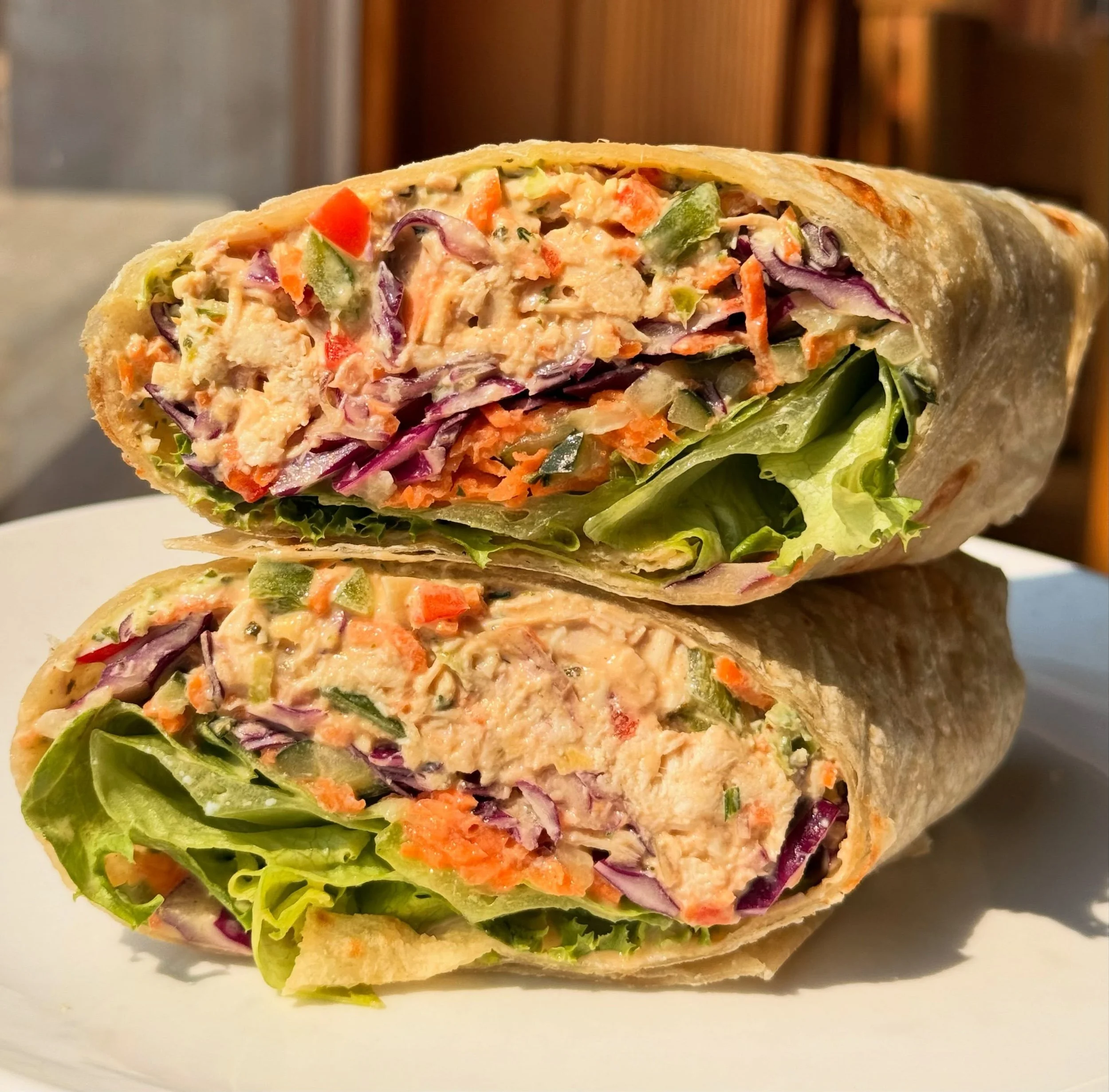 Thai Peanut Chicken Salad Wrap! Wrapped up in a @cupsandmemories handmade flour tortilla with our house cilantro jalape&ntilde;o aioli, lettuce, pickled cucumbers and carrots and fresh purple cabbage. You&rsquo;ll be back for another!! 

#lunchtime #