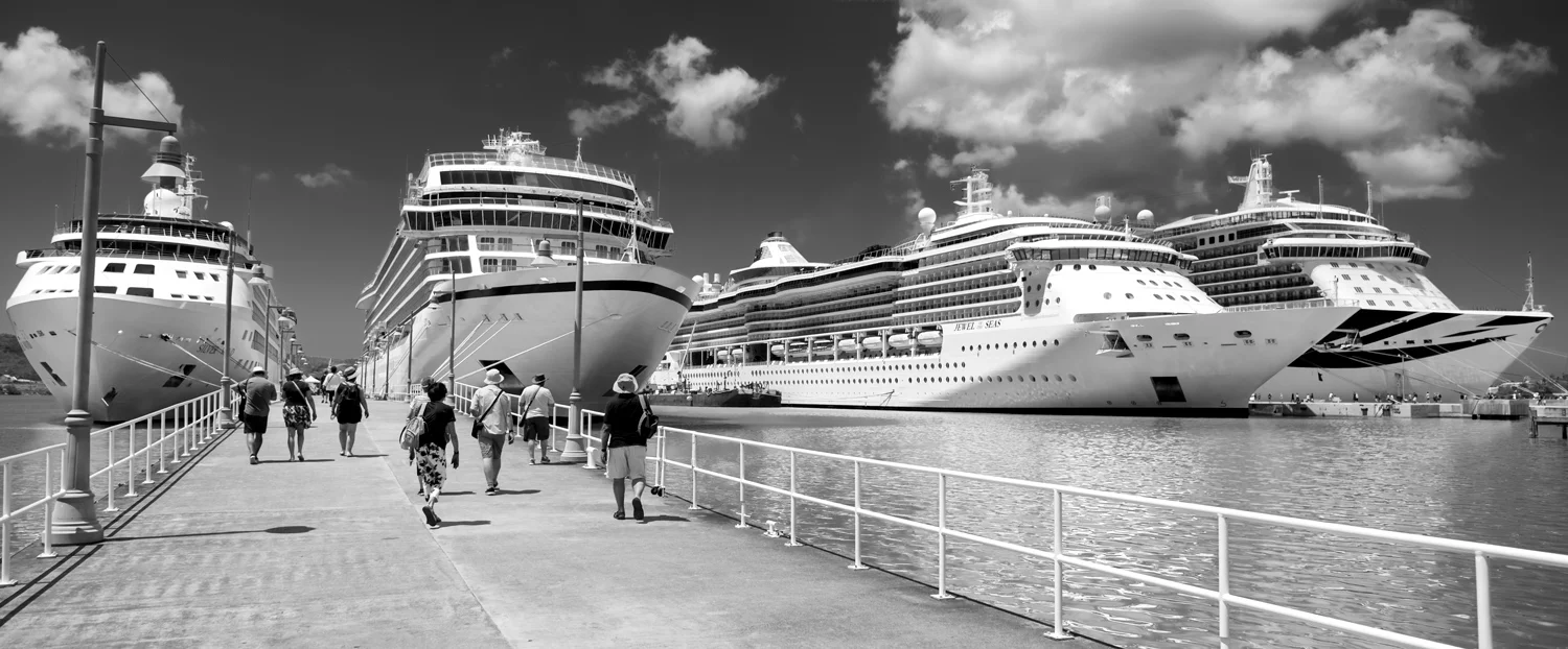 FOUR CRUISE SHIPS (Photograph)Cruise ships, St Johns, Antigua (2018). From left to right (with passenger capacity) are Silver Wind (294), Viking Sea (930), Jewel of the Seas (2501), and Britannia (4324).