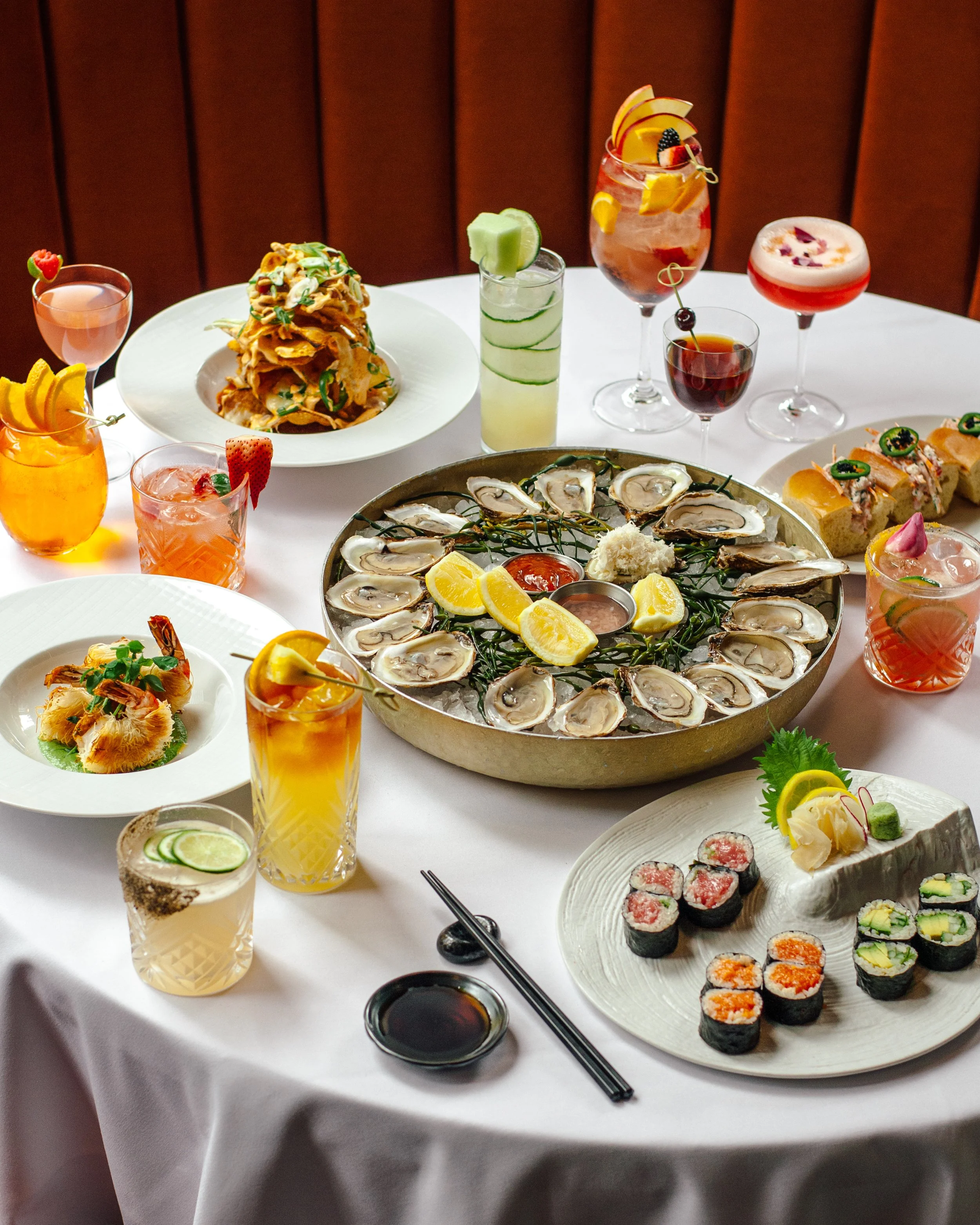 Table of food including oysters and cocktails