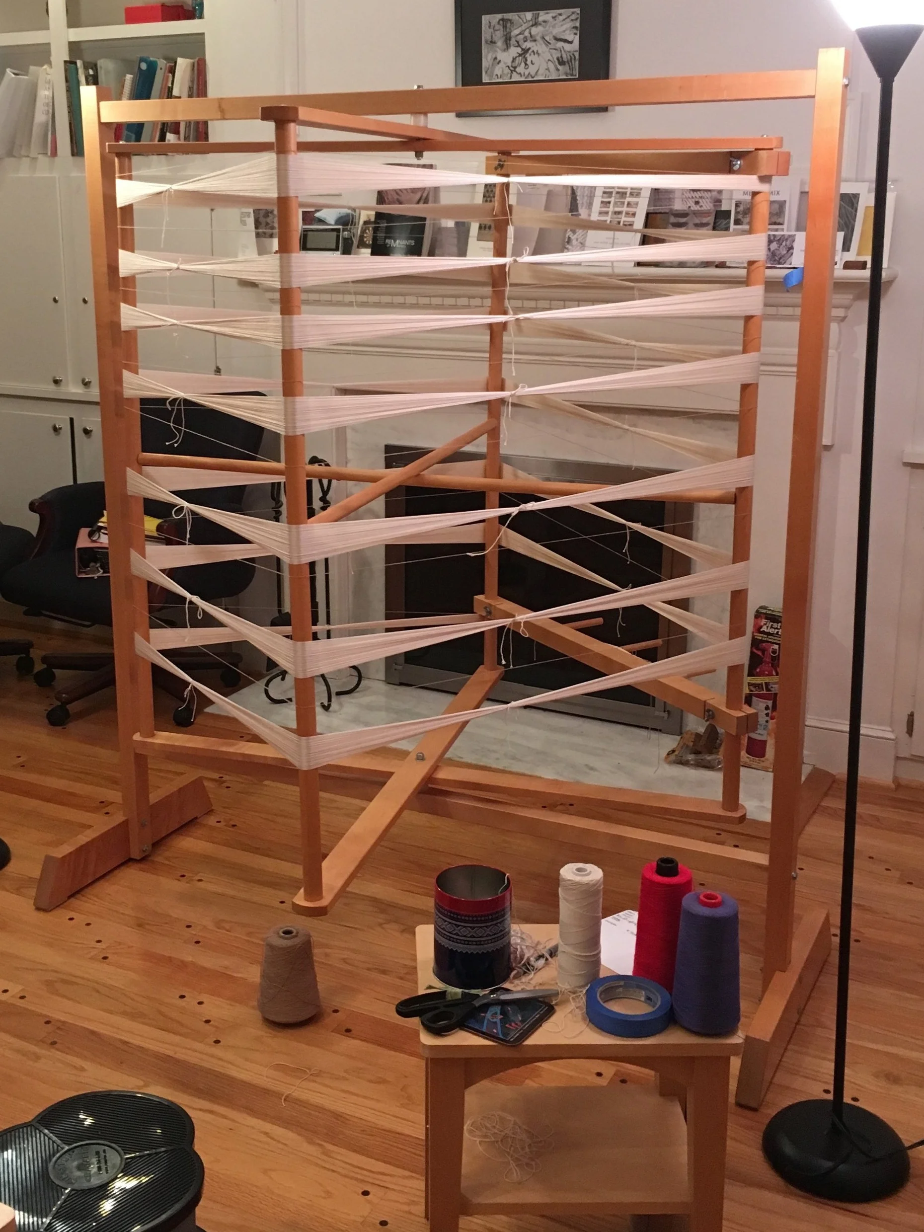 I use this to wind my warps. This holds up to 50 yards. This isn’t my own studio set up- but is the best image I have for this wheel. Note the handy table nearby, the stool- the cool can for saving the ties.