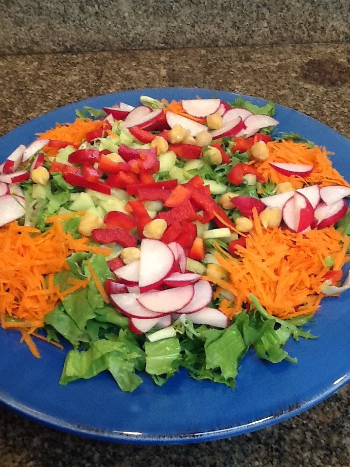 I love making a big salad early I the week. Cover it with a paper towel and plastic wrap and you have a go to salad for at least 3-4 days. This all depends on how fresh your lettuce is. Hopefully it has been purchased at your local farmers market.
This week I took advance of the fresh Frisée and Escarole. They originally came from the Mediterranean region.
Frisée Is sometimes referred to as chicory. Related to endive.
Escarole is from the same family of vegetables.
I especially like the different textures of both the Frisée and Escarole. Curly and crunchy, smooth and full of flavors. Simply said, just delicious.
Because they are not known as the sweetest of lettuces. I like to pair them with an assortment of sweeter options.
So I added
Grated carrots
Radishes
Celery
Parsley
Red bell pepper
Cucumber
A handful of garbanzo beans
And I topped it off with cubes of avocado
Dressing: basic vinaigrette is 1 tablespoon apple cider vinegar, or fresh lemon, or orange or grapefruit juice to 3 Tablespoons of olive oil.