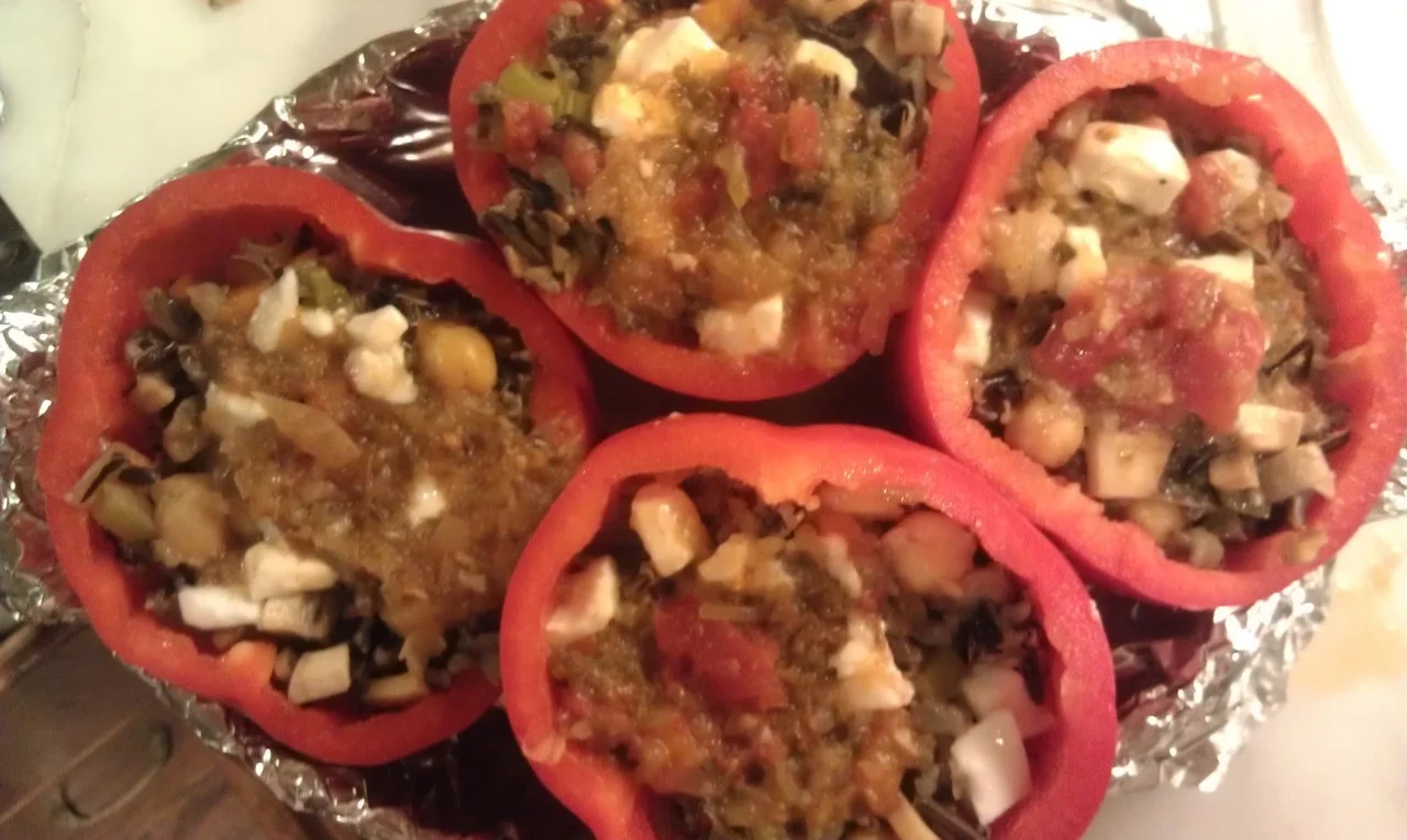 Stuffed Peppers
4 Red Bell Peppers (you can use any color)
2 Tbsp Olive oil
1 cup wild rice
2 cups vegetable stock (or water)
1 onion, chopped
1 clove garlic, finely chopped
1 stalk of celery, sliced thinly
1 small zucchini squash, diced very small
¼ cup parsley
½ cup chickpeas
½ cup fresh mozzarella cheese(optional)
½ cup taco sauce (see recipe on my blog)
1 tsp salt
pepper
Topping: Sliced radishes, avocado, roasted pumpkin seeds
Heat the oil in a medium sized pot and add the onion and saute for about 6 minutes, add the zucchini, celery and the garlic, cook for a few more minutes. Add the wild rice, and stock, salt and pepper and cook for about 45 minutes, or until the rice is done. Stir in the parsley and chick peas and a little of the fresh mozzarella cheese. Spoon some of the taco sauce over each pepper. Put in a baking dish and bake in a 350 degree over for 20 30 minutes.
Before serving, top with sliced radishes, avocado and roasted pumpkin seeds.
