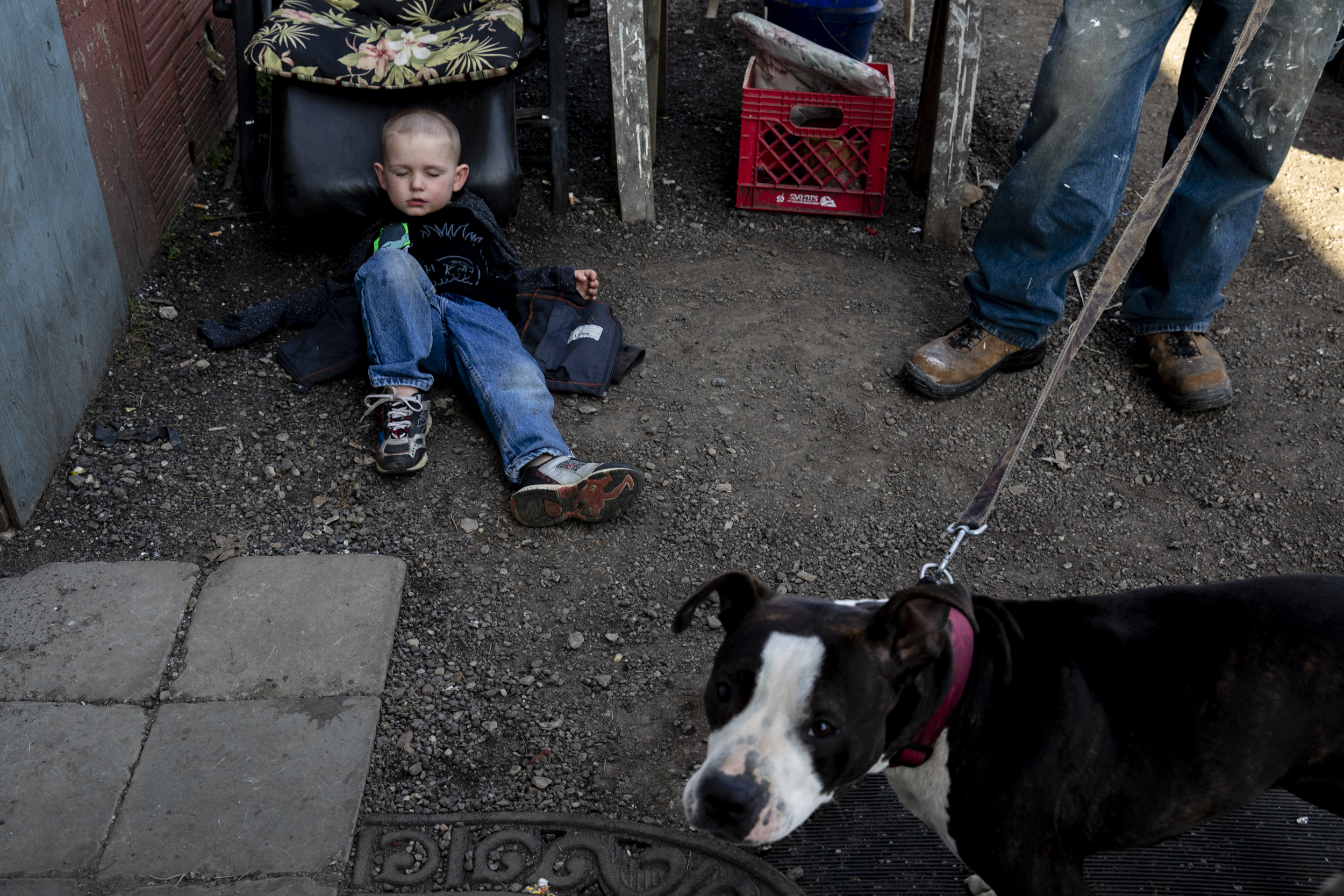 A young boy, 5, (name withheld) plays dead outside of Tent City in Akron, OH, where roughly 50 of Akron’s homeless live. Both of the boy’s parents are homeless. According to the US Census Bureau, 25.4% of Akron’s population lives below the poverty line.