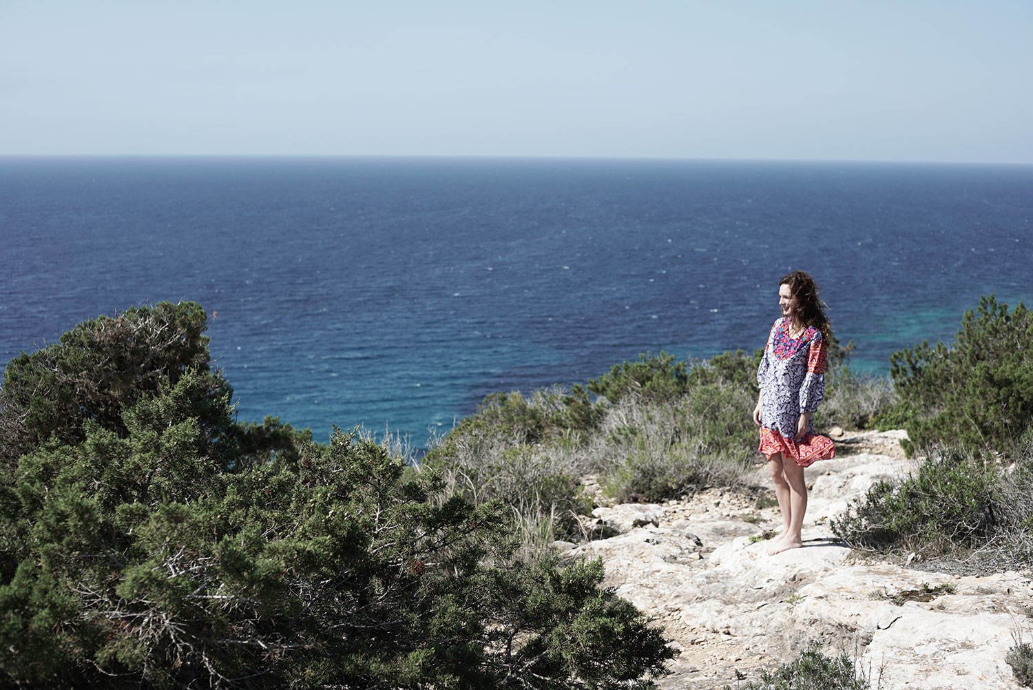 Formentera dress on cliff overlooking ocean