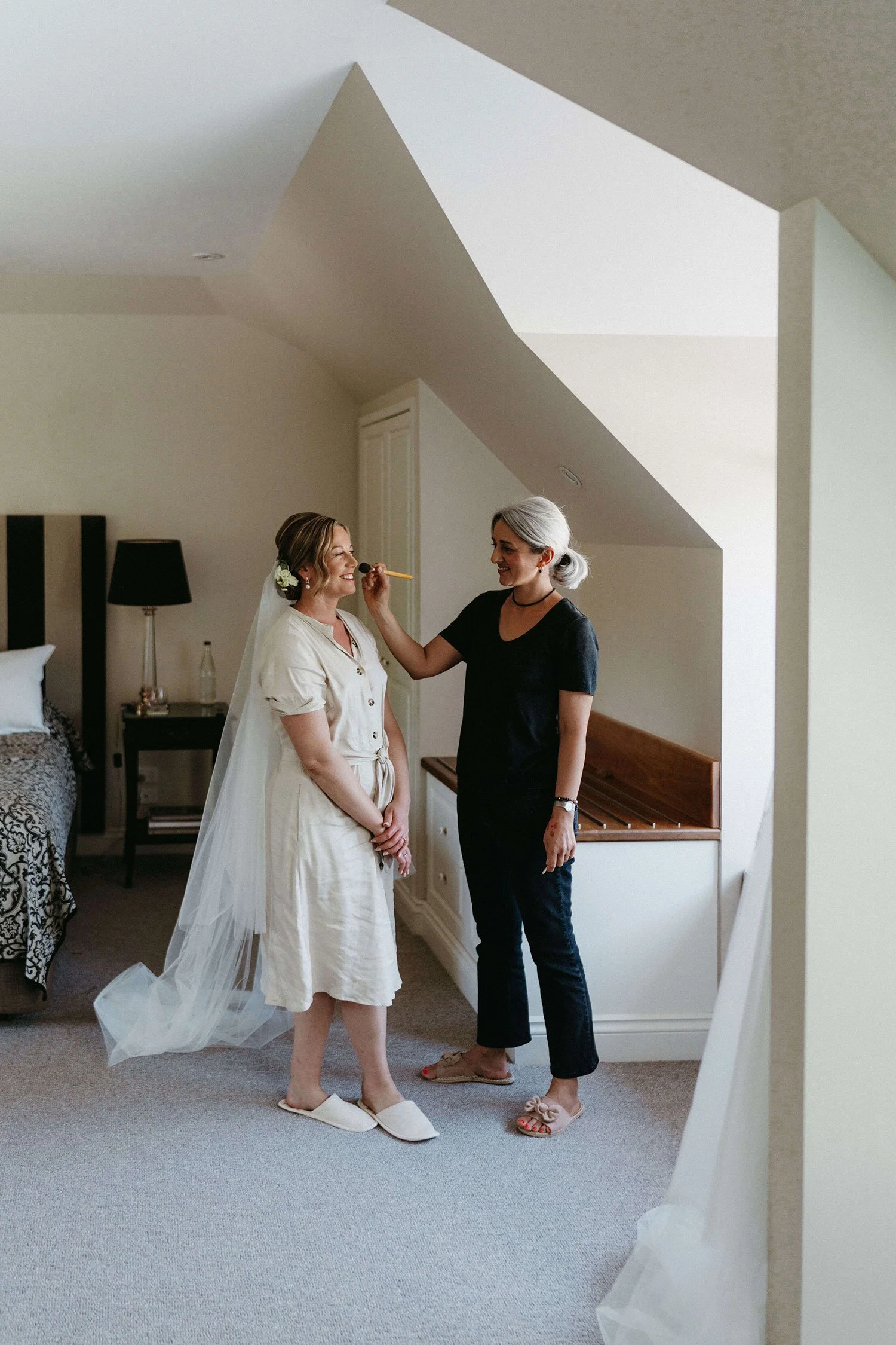 Tasleema Nigh, an international makeup artist with 25 years of experience, applying refined and luminous wedding makeup for a bride on the Sunshine Coast.