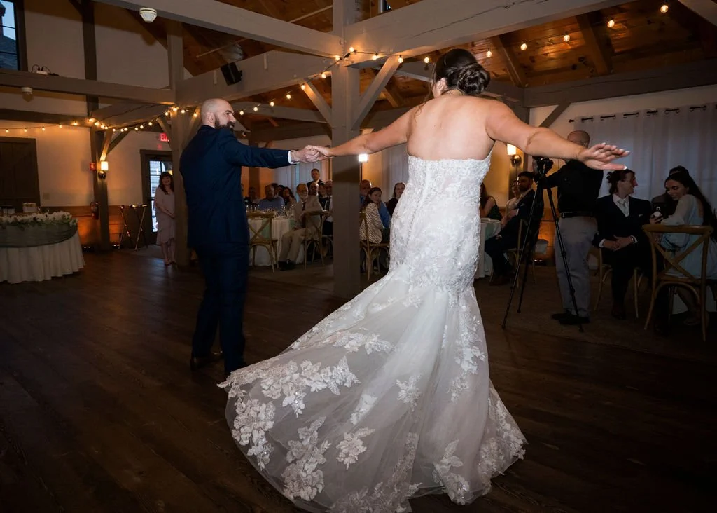 Kelley and Daveed dancing beneath the reception room’s timber beams