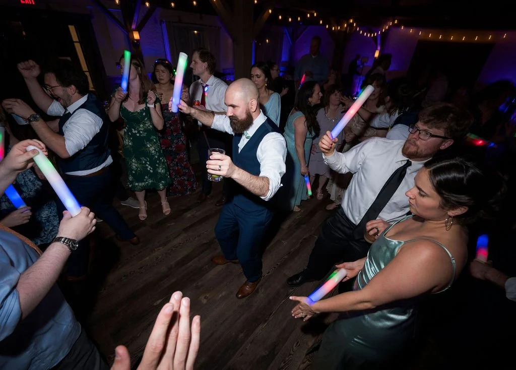 Daveed and wedding guests dancing with glowing light sticks