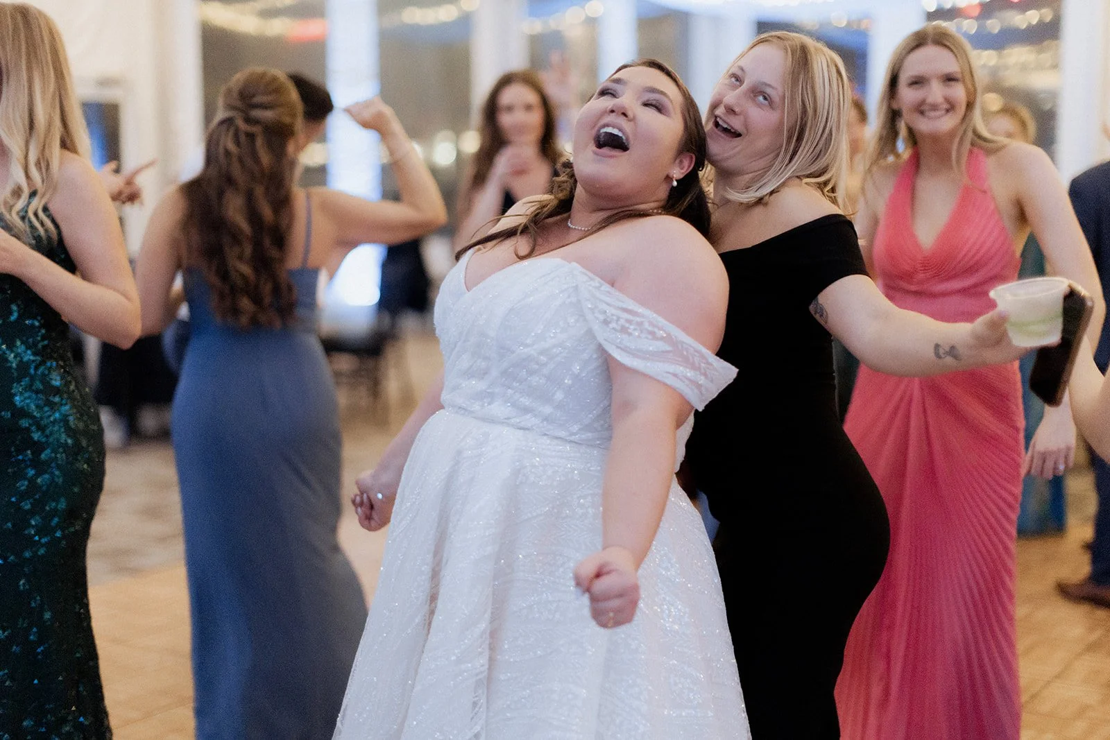Sarah celebrating with friends at her New England Aquarium wedding
