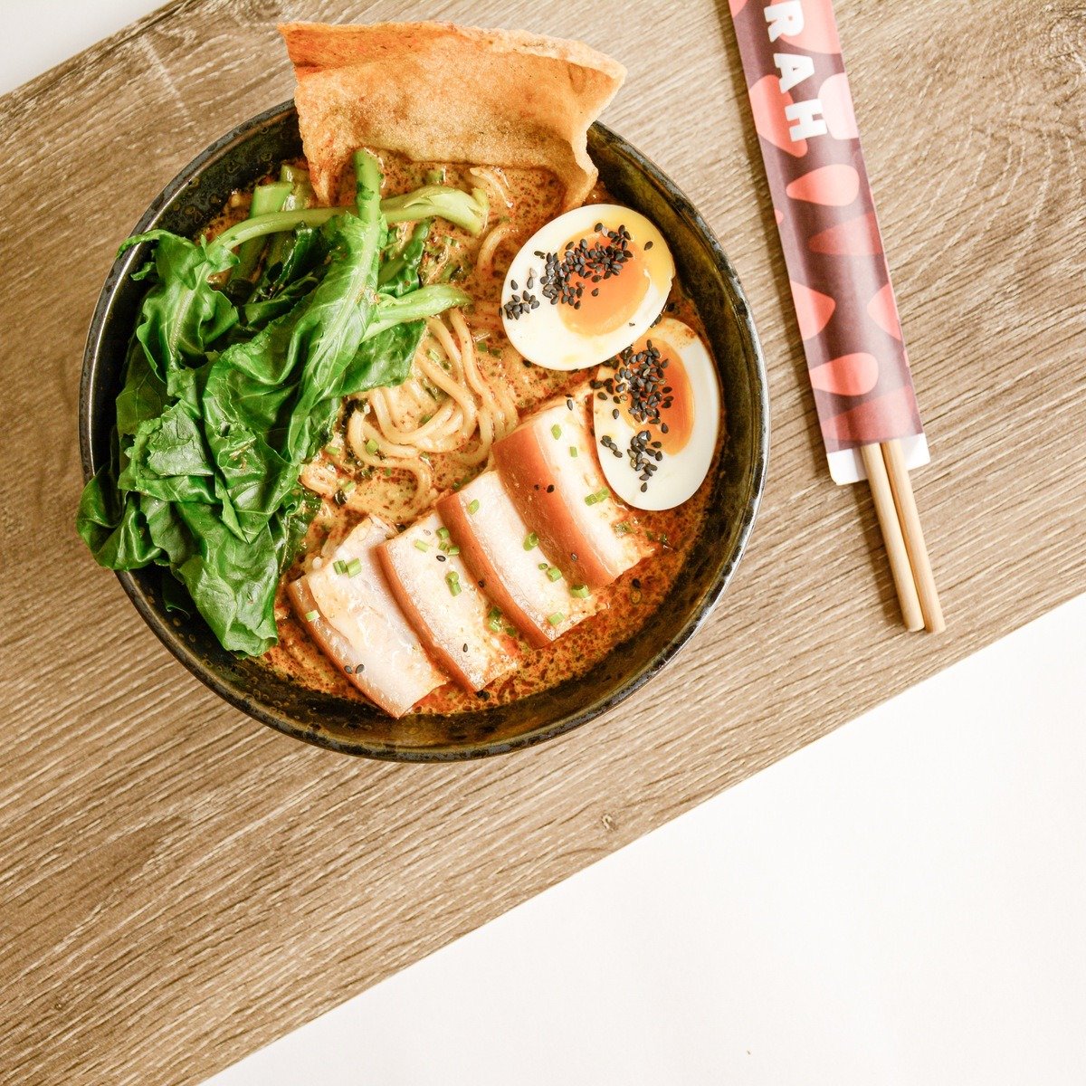 Dive into our Braised Pork Laksa at Restaurant Merah! Featuring ramen-style noodles and our signature creamy curry laksa broth, this dish is pure comfort in a bowl. Our pork belly is braised for 24 hours to perfection, making every bite melt in your 