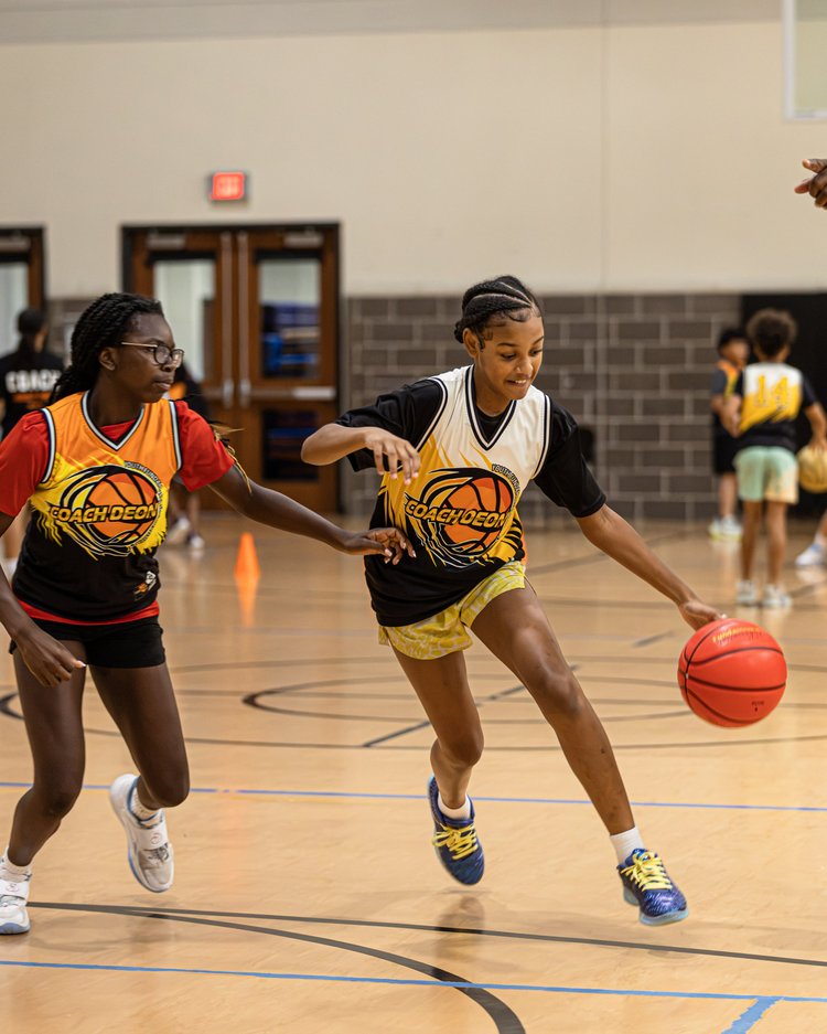 Young athletes competing during a Coach Deon Basketball summer camp activity