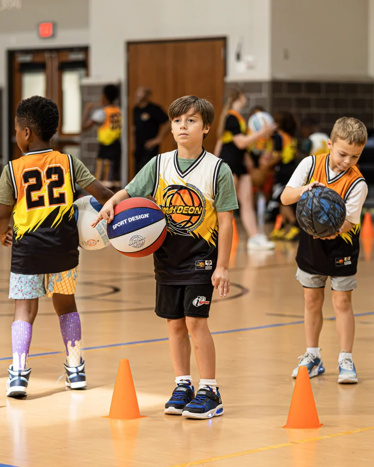 Coach Deon Basketball campers learning and growing in a structured gym environment