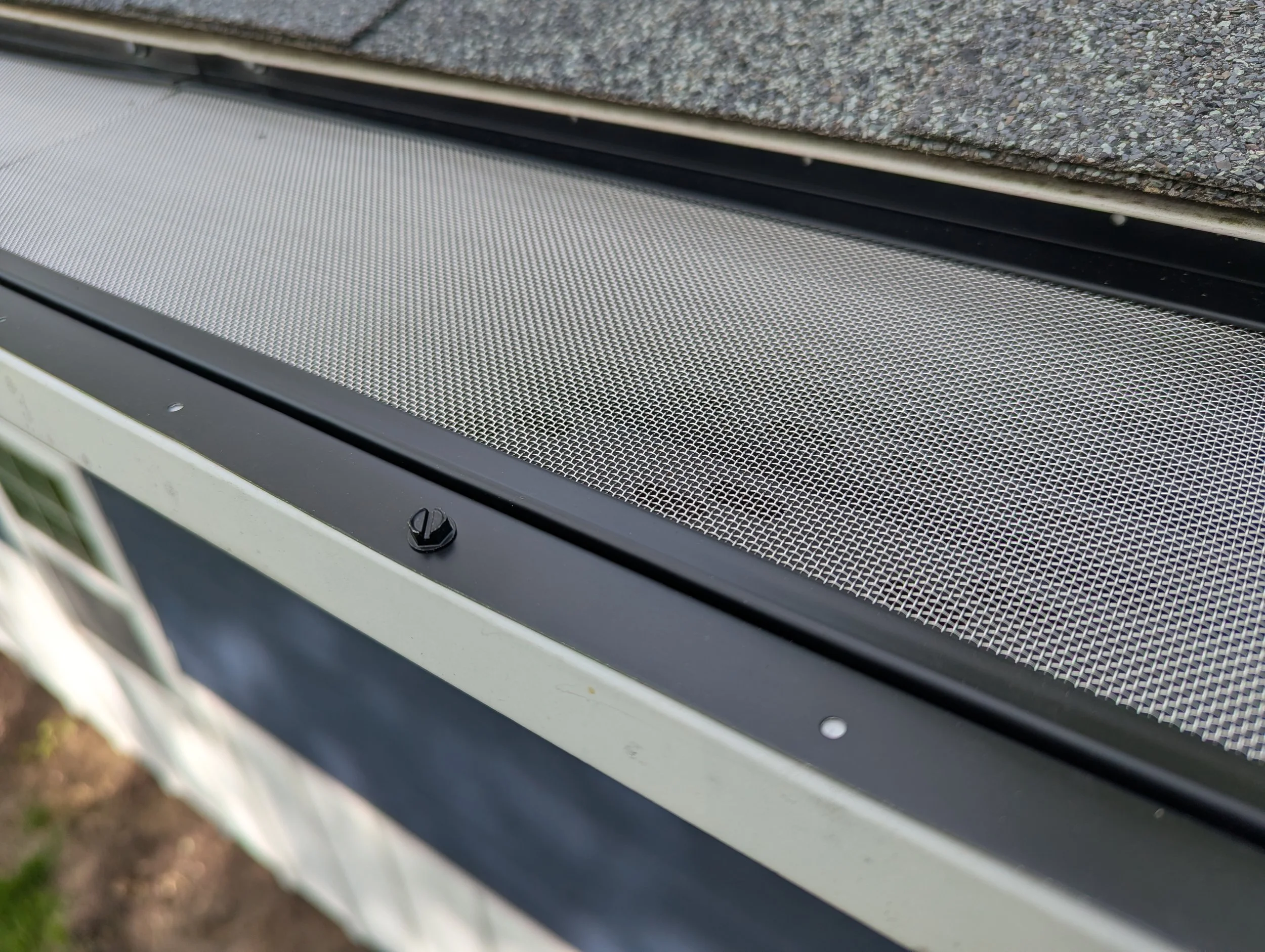 Close up photo of Hydro-flo leaf guard installed on residential gutters.