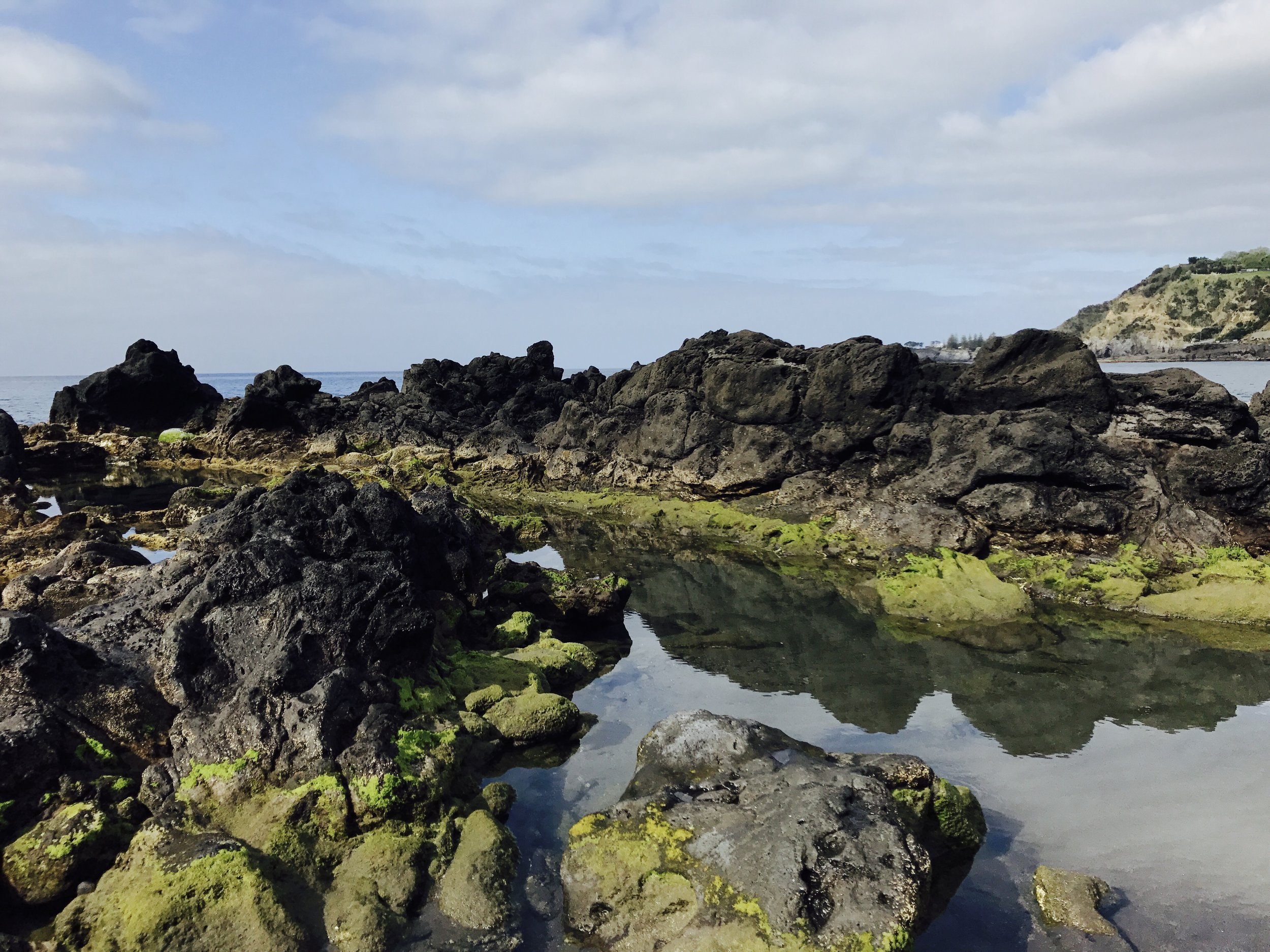 Local beach that is usually crowded in the summer. We were the only ones there. Those are volcanic rock / lava surrounding these natural pools.
