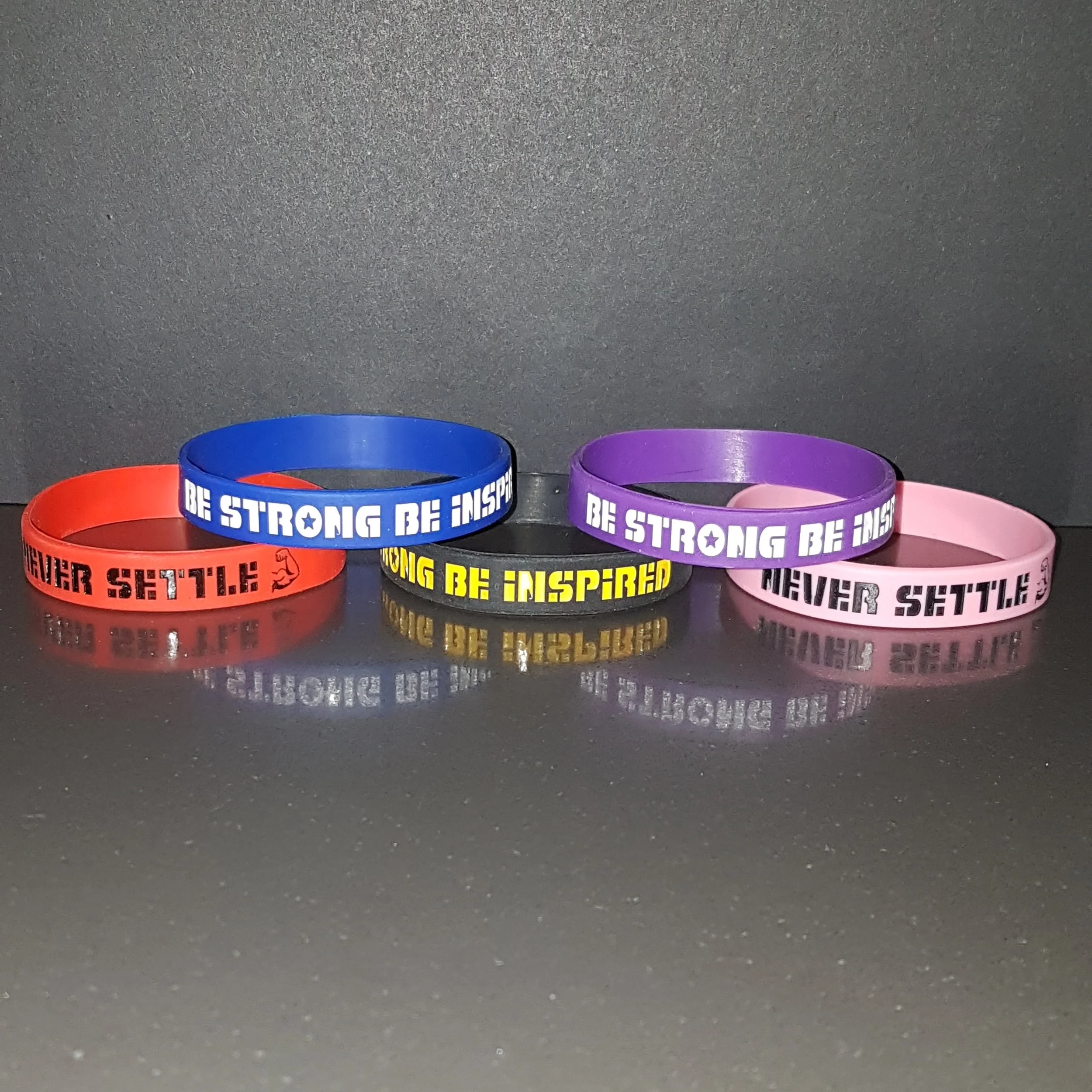 "BE STRONG, BE INSPIRED, NEVER SETTLE" STRENGTH BANDS