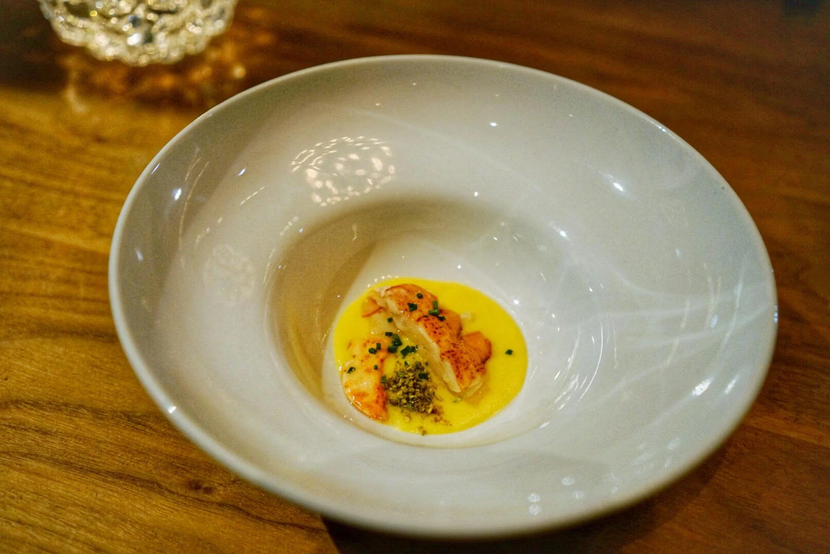  butter poached lobster with sweet corn puree and pistachio togorashi 