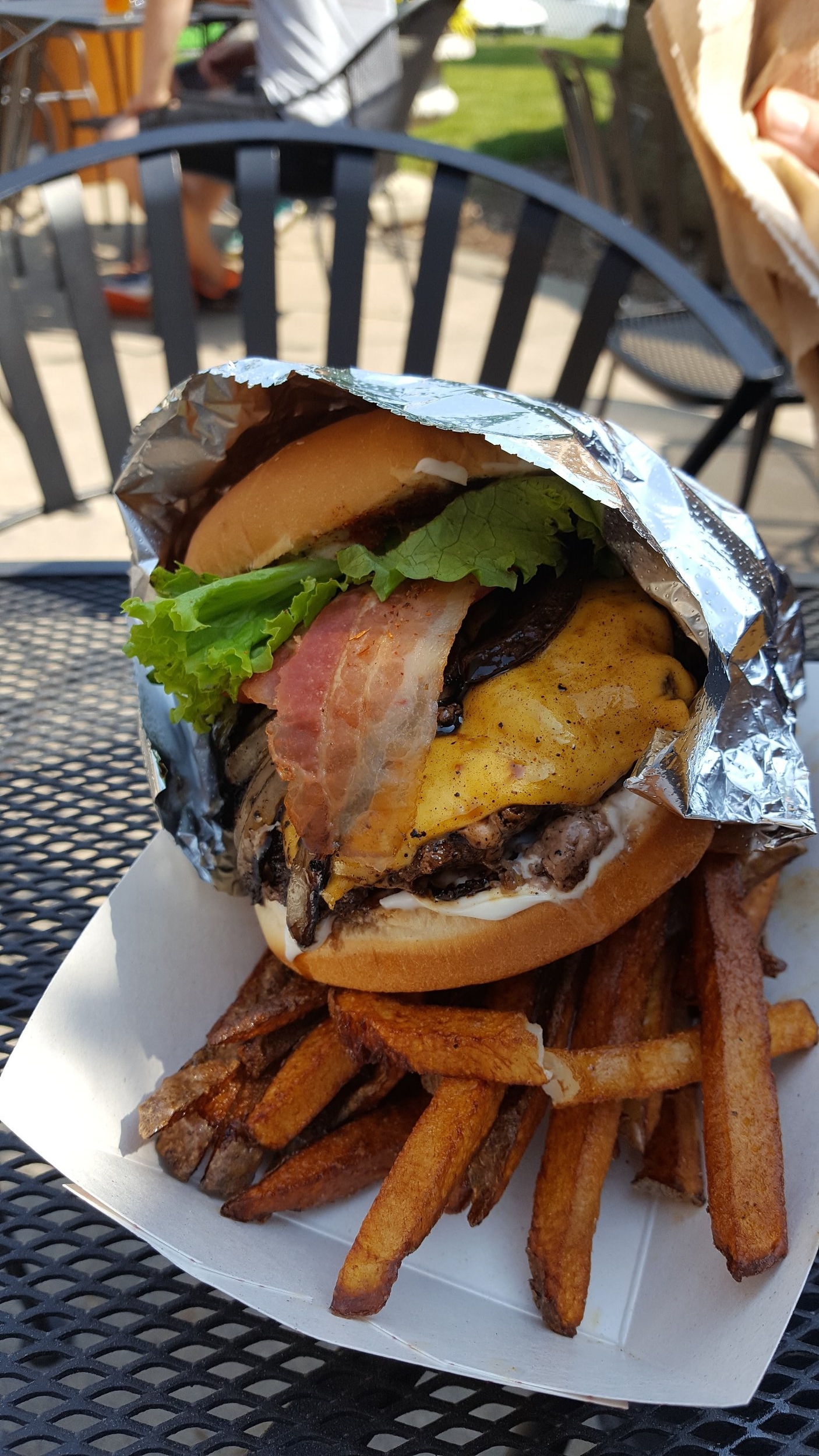  This burger looks like it ould take a bite out of you, so monstrous and tasty! 