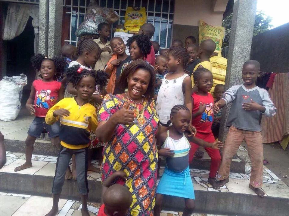 The children are dancing and singing on the steps of their new home.