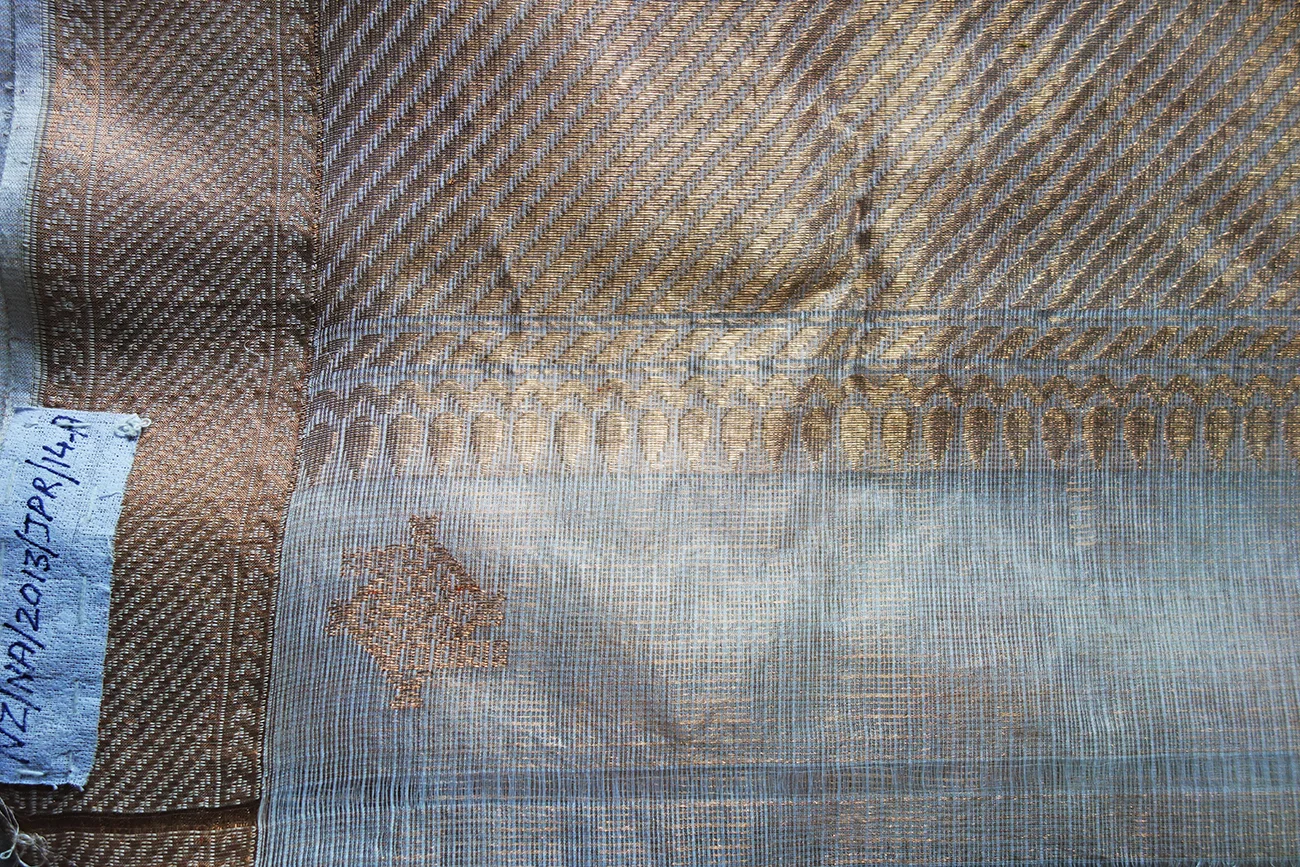 The kota doria GI mark woven into the border of a sari