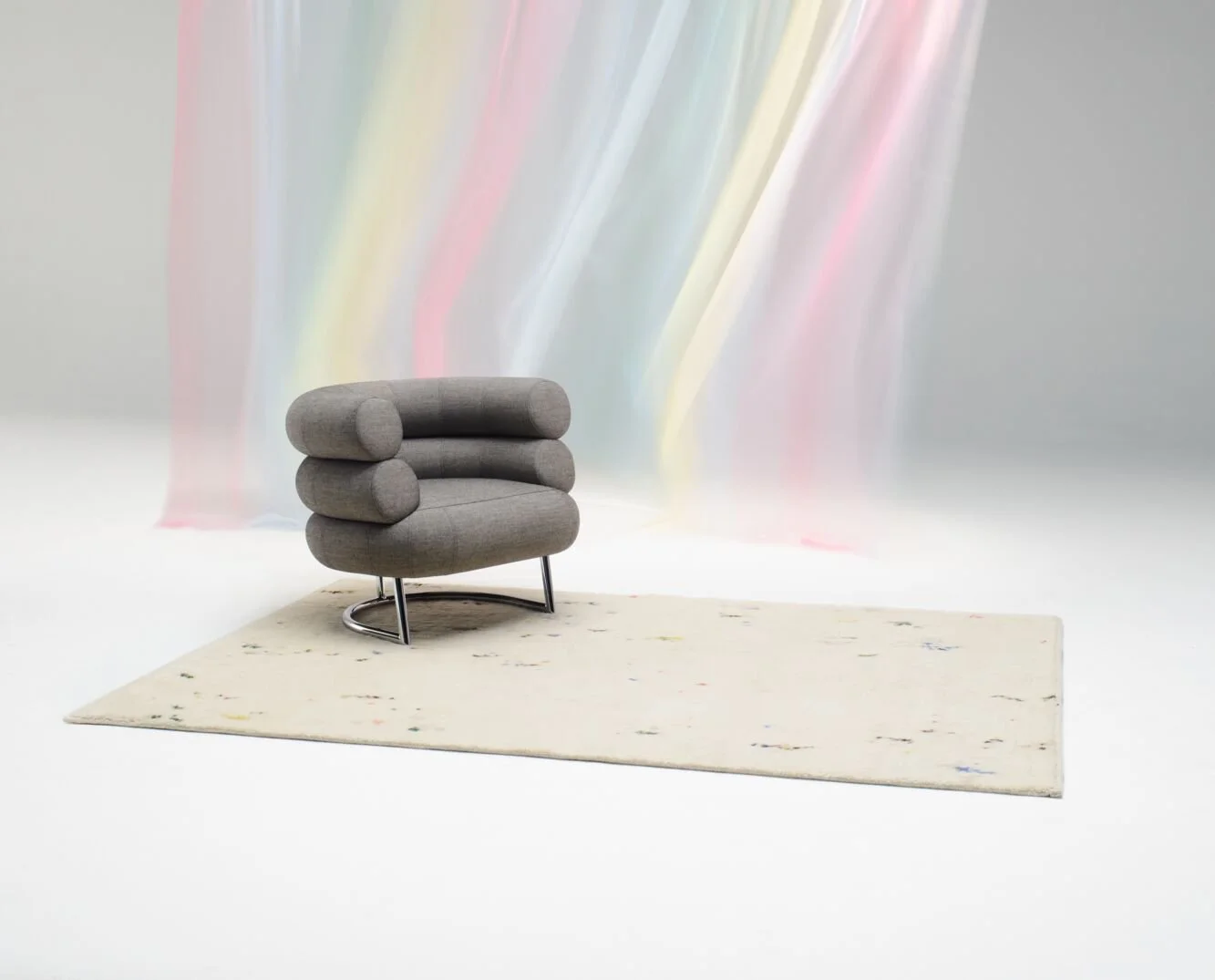Image of an occasional chair on a Kvadrat Technicolour Fleec rug.