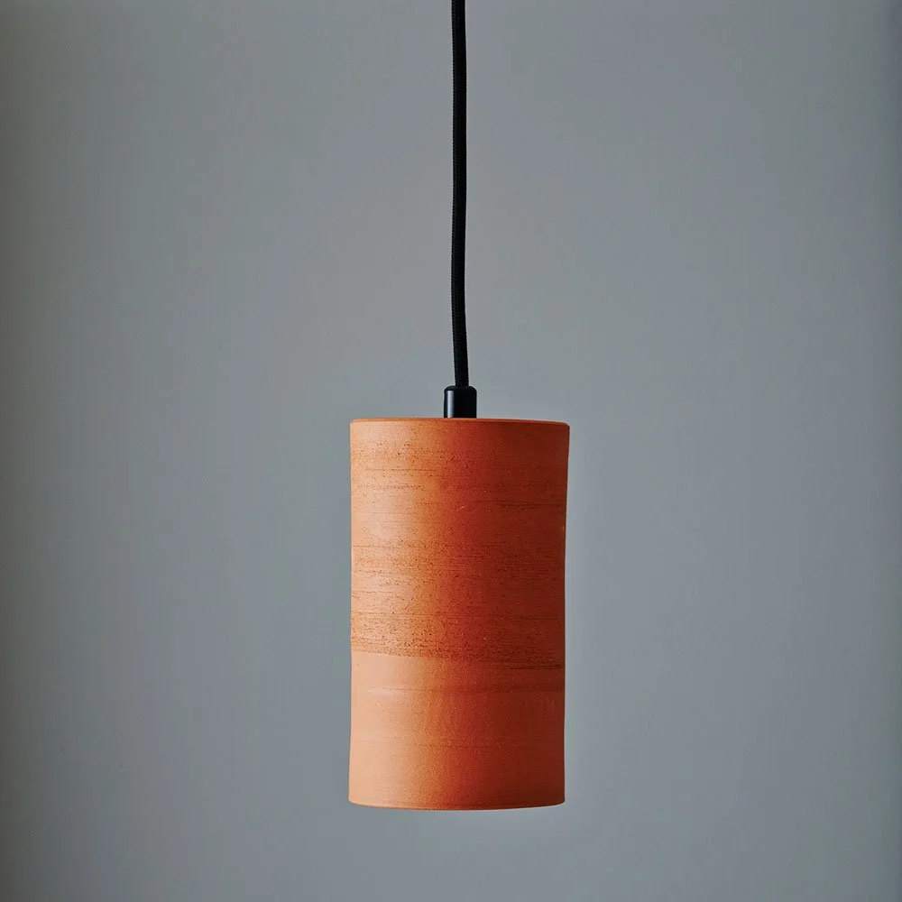 Images of an Anchor Erath pendant in Terracotta and black cord.