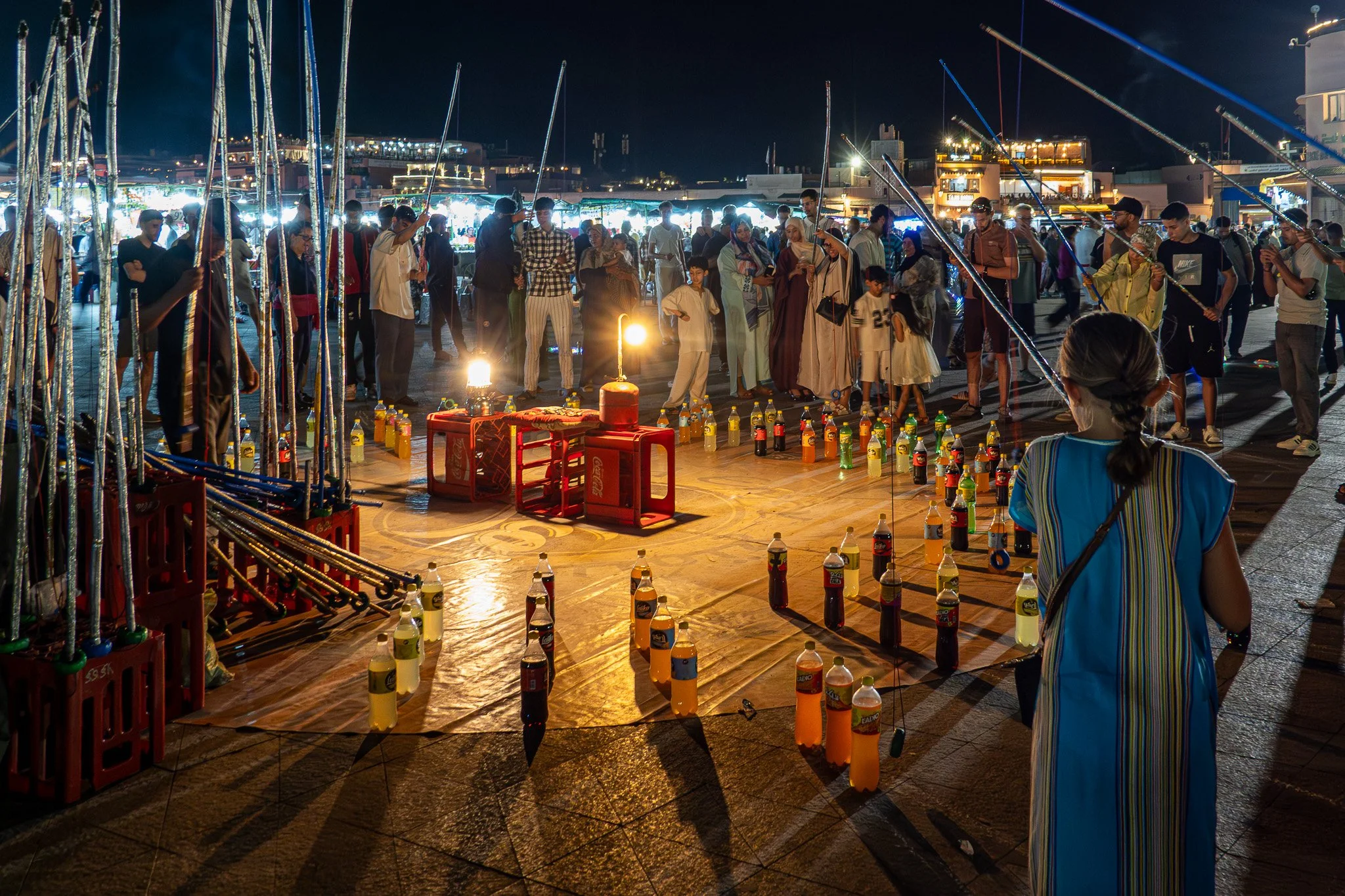 Alistair How - Non-alcoholic bottle fishing Marrakech - Shot at the night market. Challenge was low light and not being clocked by the audience! Sony RX100, 10,8mm (24 equivalent), 1/13, f3.2, ISO 800