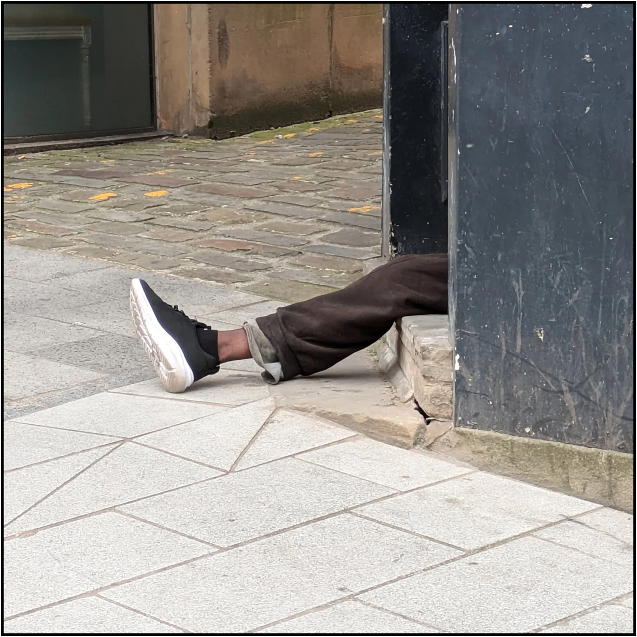 Len Downes - Legless In Leeds - On The Headrow in Leeds, I saw two legs sticking out of the doorway and thought it was interesting. By the time I had my cameraphone ready, one leg had been drawn in.  Google Pixel 7a, 1/610sec.