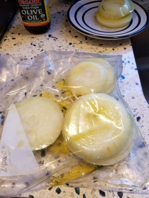 Step 3: Coat both sides of the onion slices liberally with olive oil