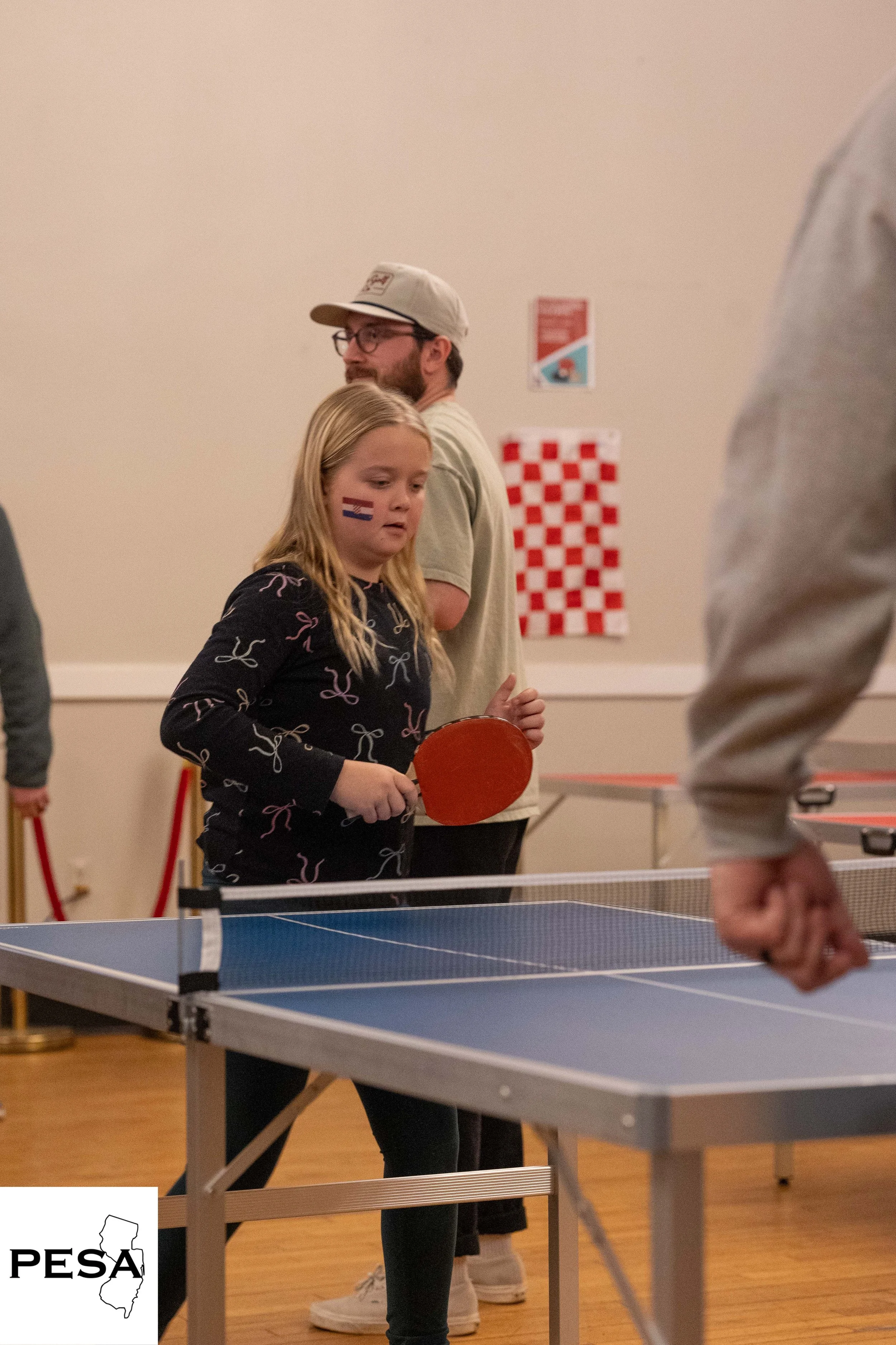 child playing ping pong