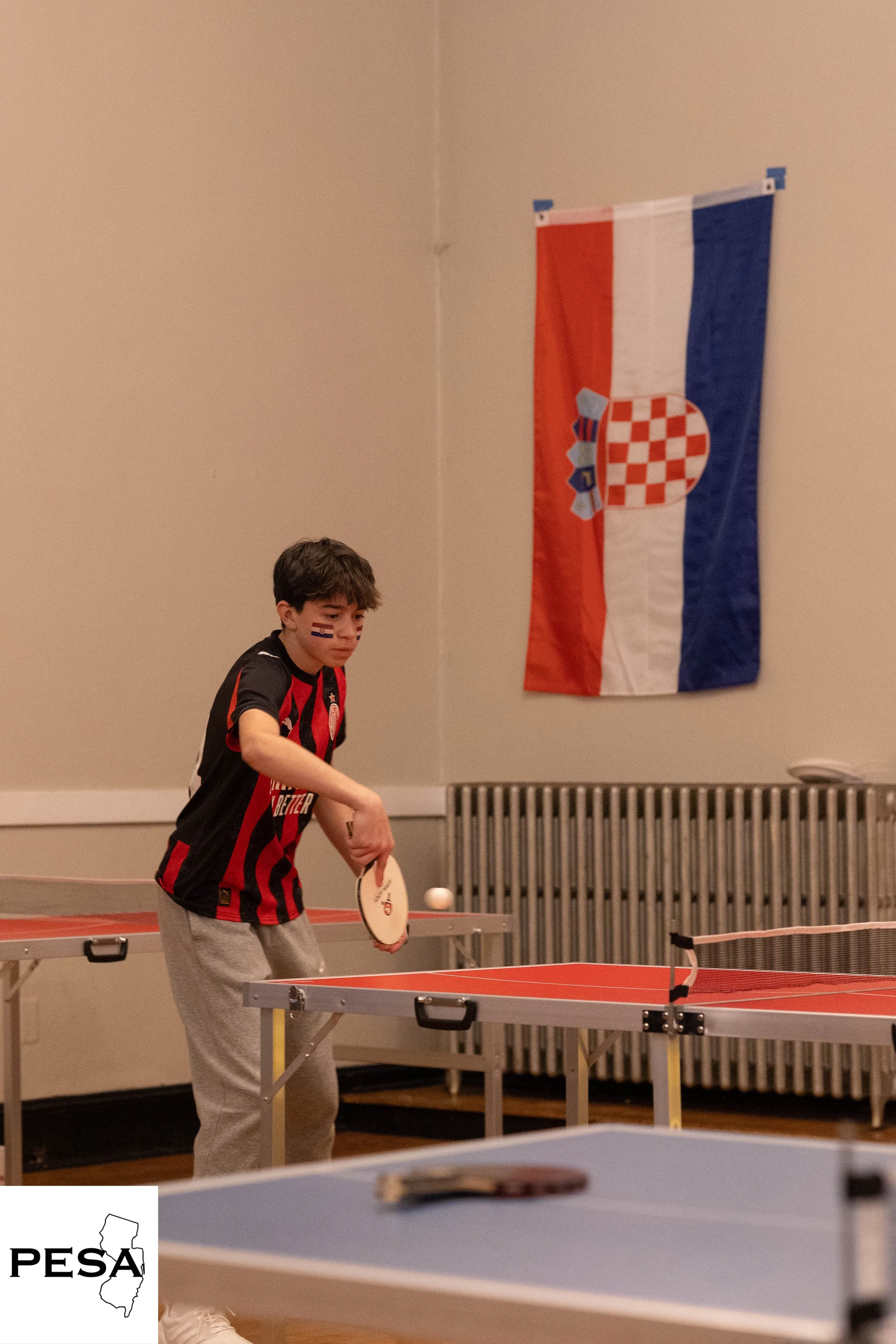 kid playing ping pong