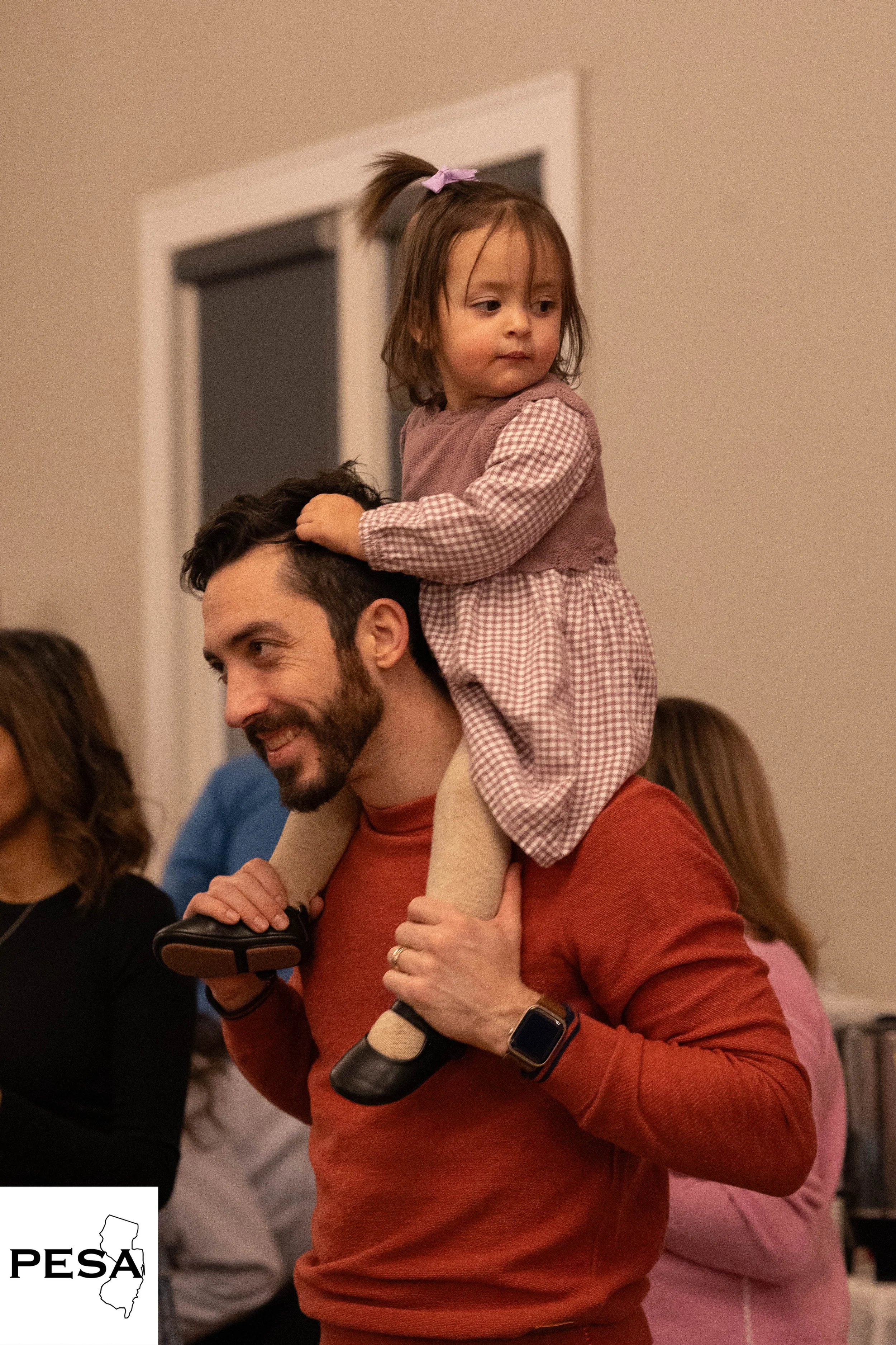 daughter on fathers shoulders