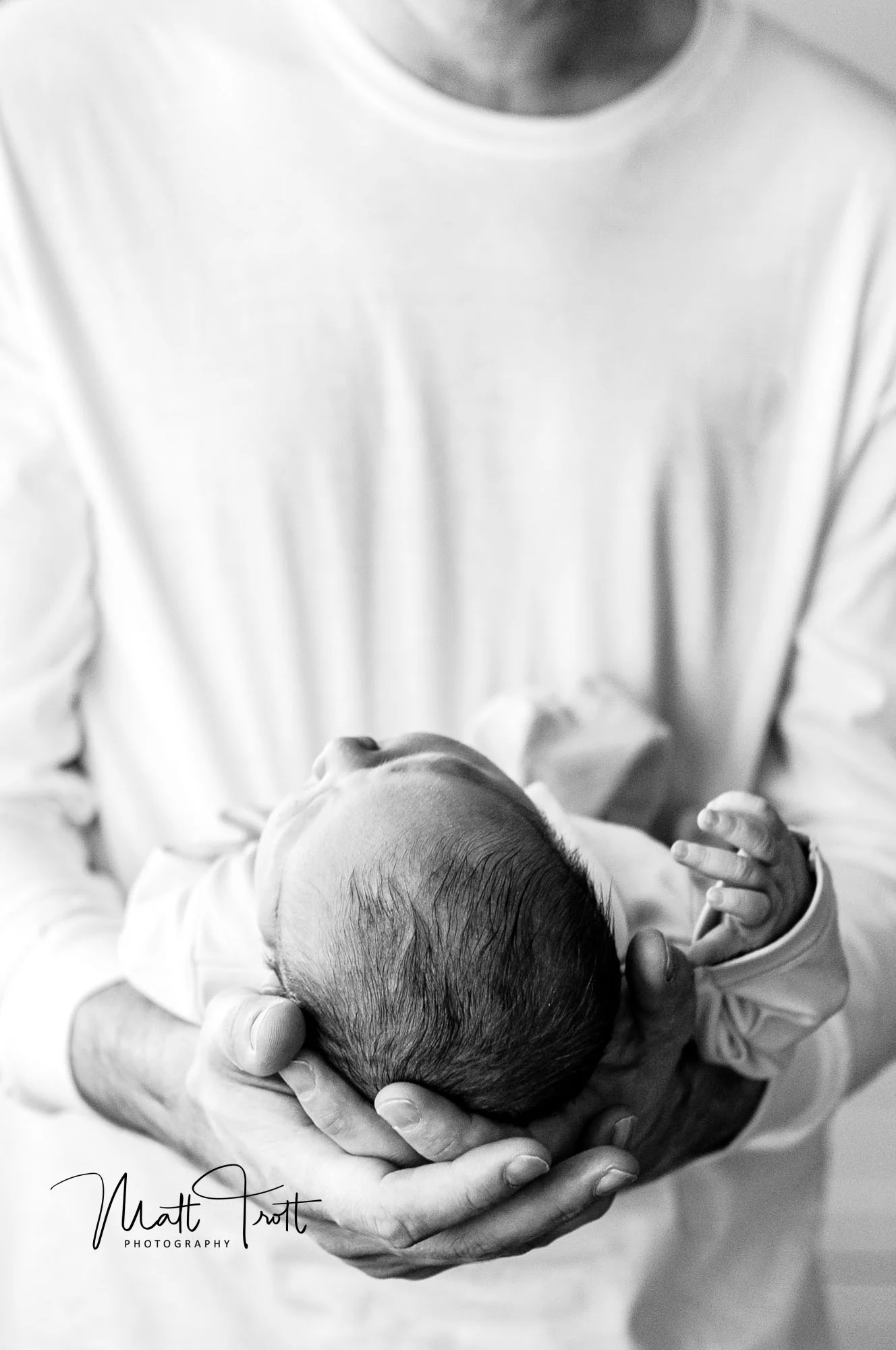 Dad holding newborn baby.jpg