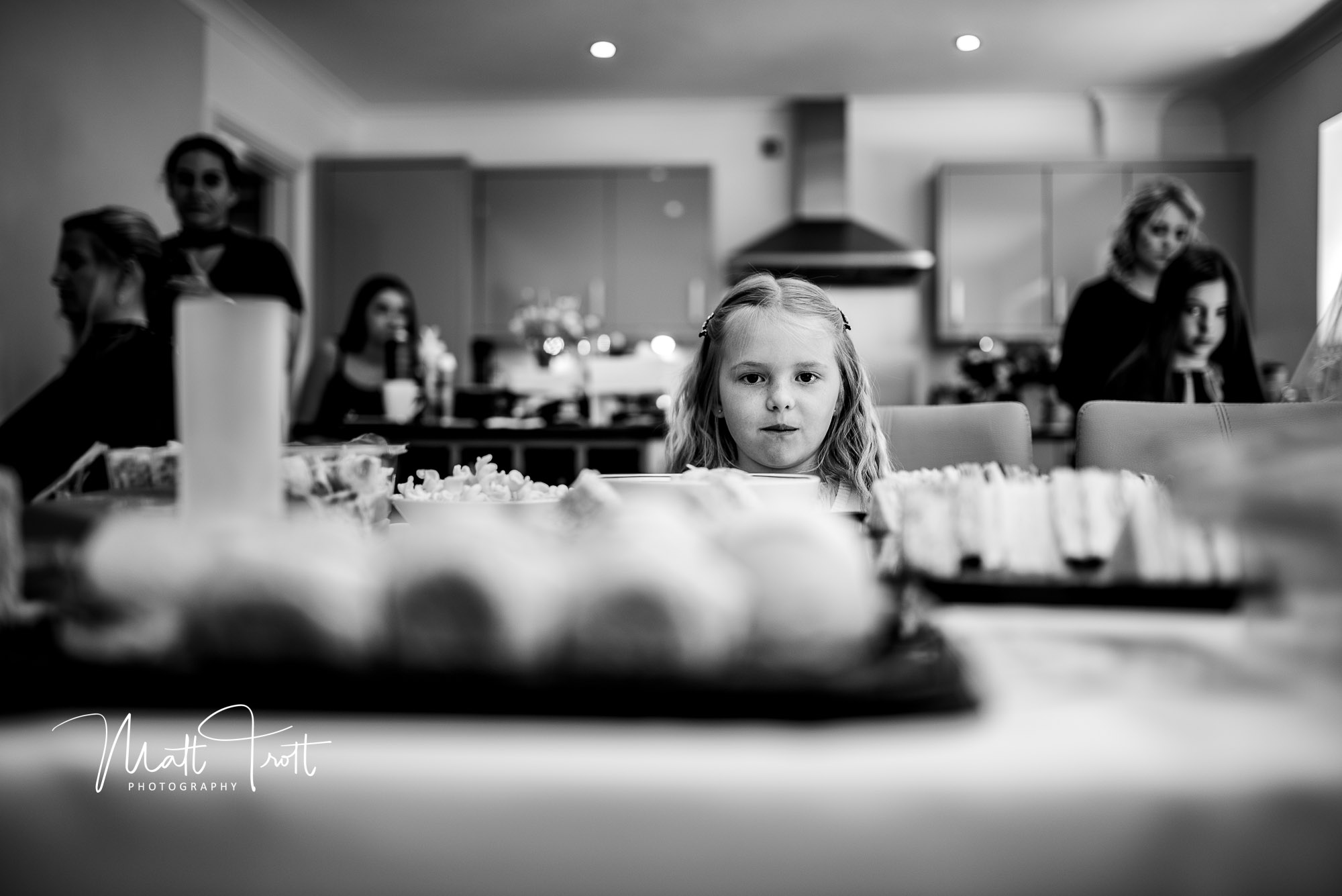 A young girl staring at all the available food and treats during bridal prep