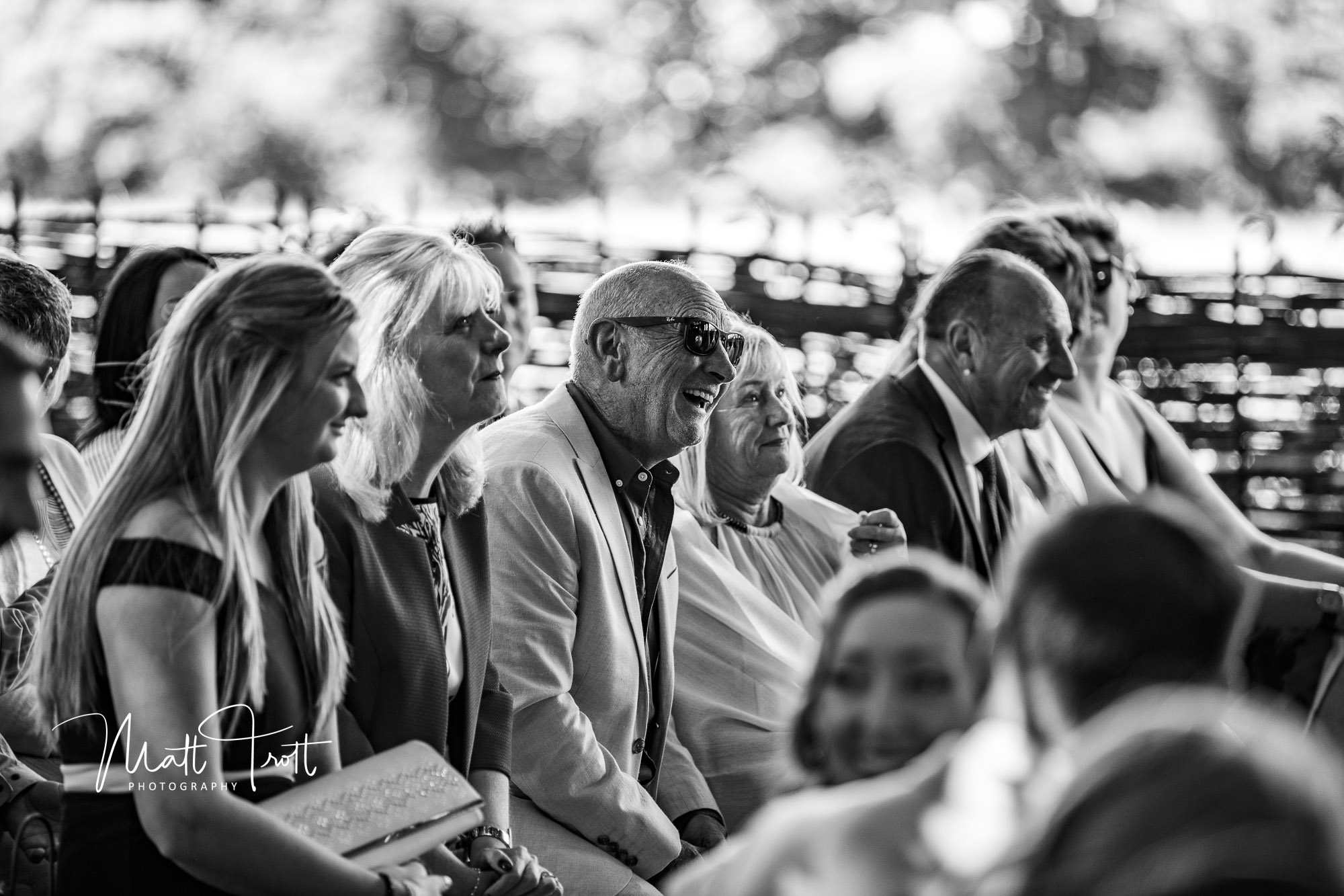 Dad smiling in the audience during a wedding ceremony