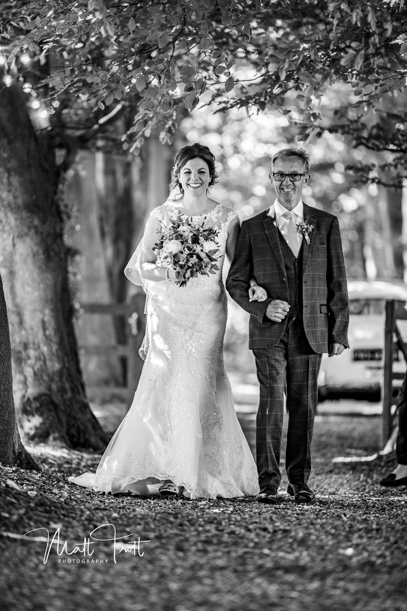 Bride and dad walking down the tree aisle outdoors at crown lodge kent