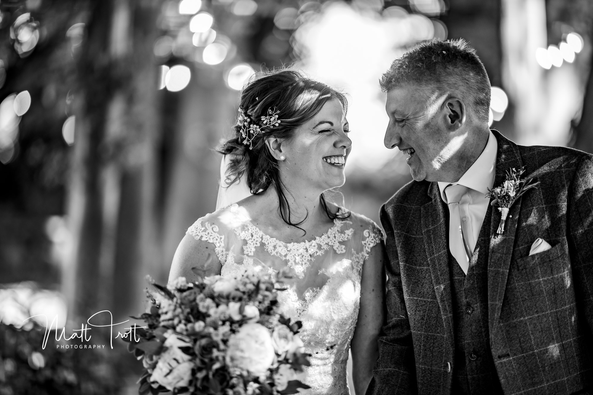 Bride and groom laughing with each other after wedding