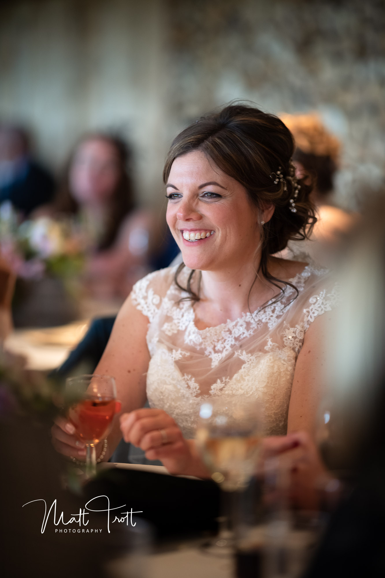 Bride smiling during her wedding breakfast