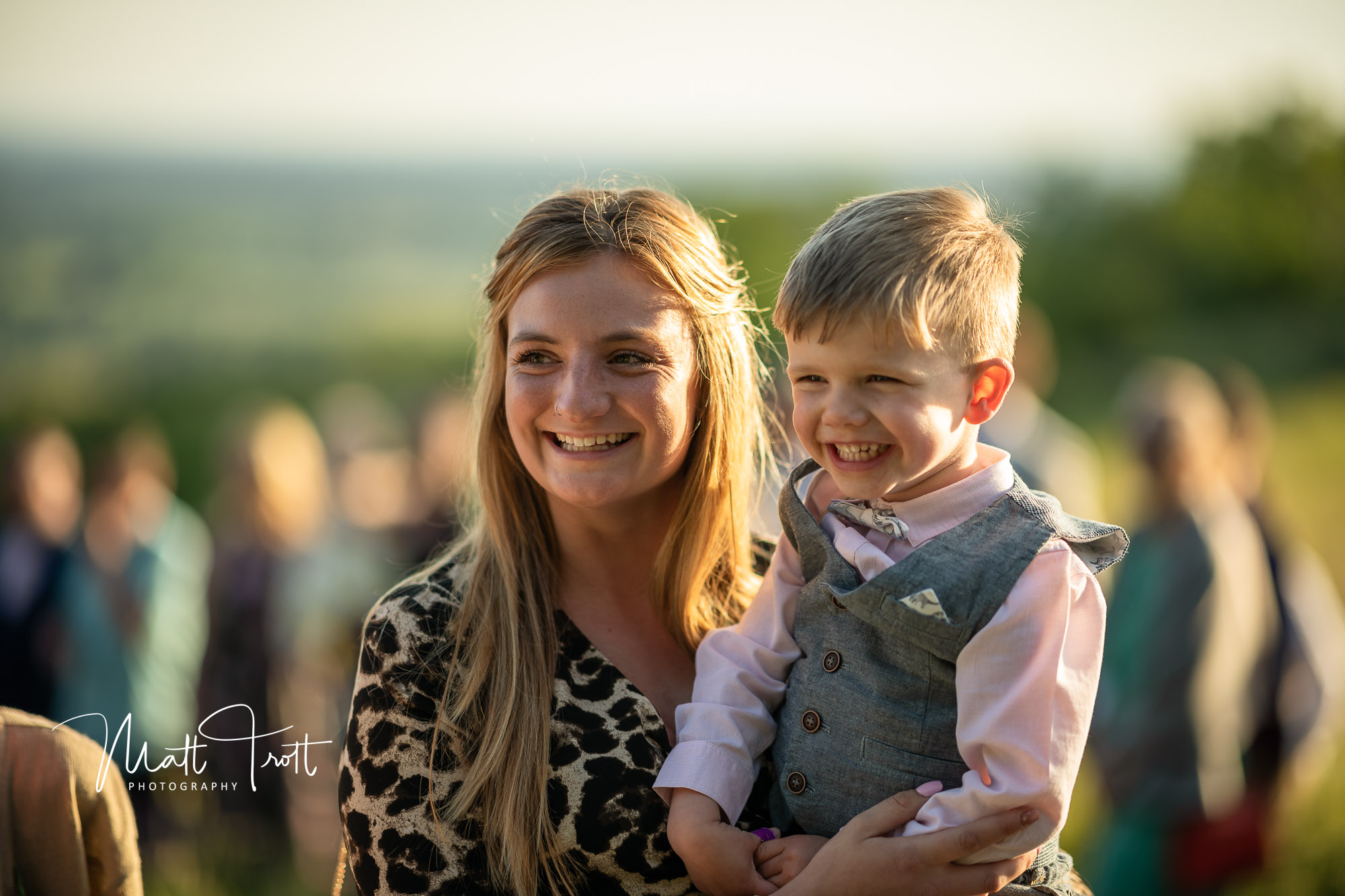 Woman and son laughing and smiling at a wedding