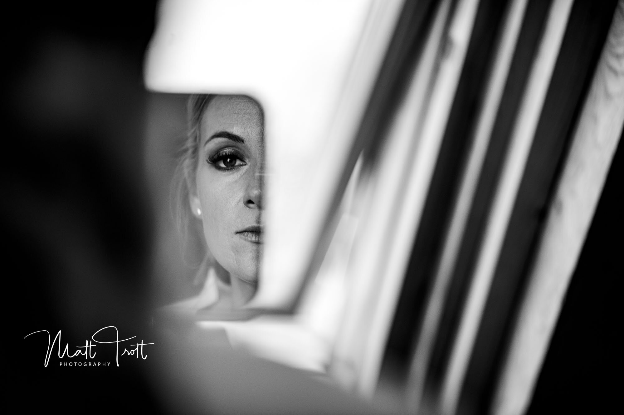 Bride looking in the mirror at her make up