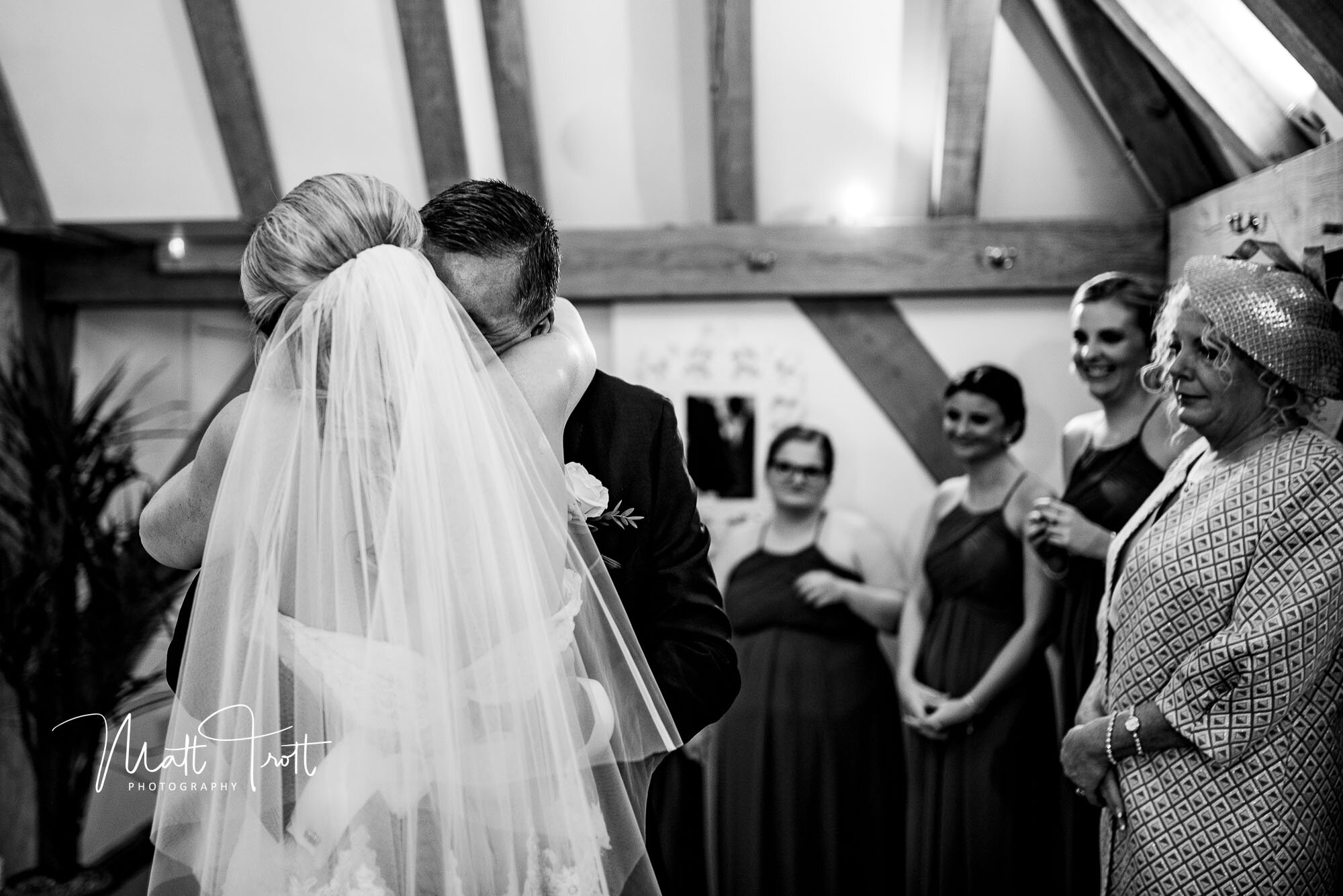 Bride and dad embrace after seeing her for the first time in her wedding dress